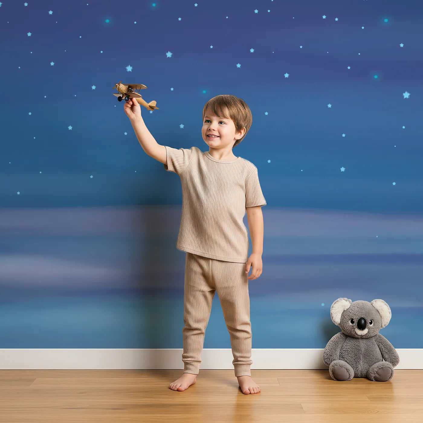 Child in front of Whimsy Tots Deep Blue Starry Night Wall Mural with star, night, sky, space, galaxy, universe, dark, blue in design.