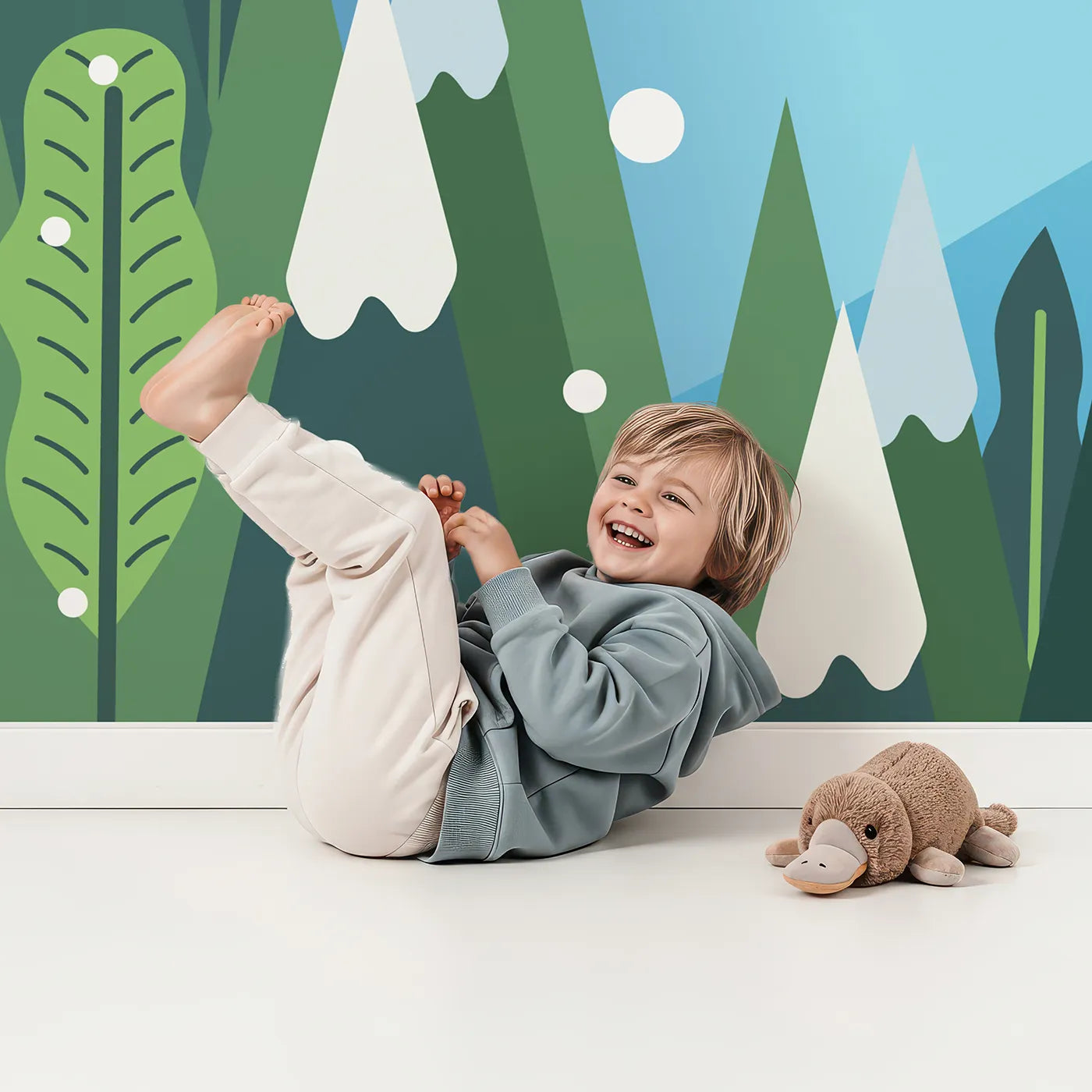 Child in front of Whimsy Tots Graphic Winter Forest Wall Mural with winter, forest, mountain, tree, snow, graphic, modern, blue in design.