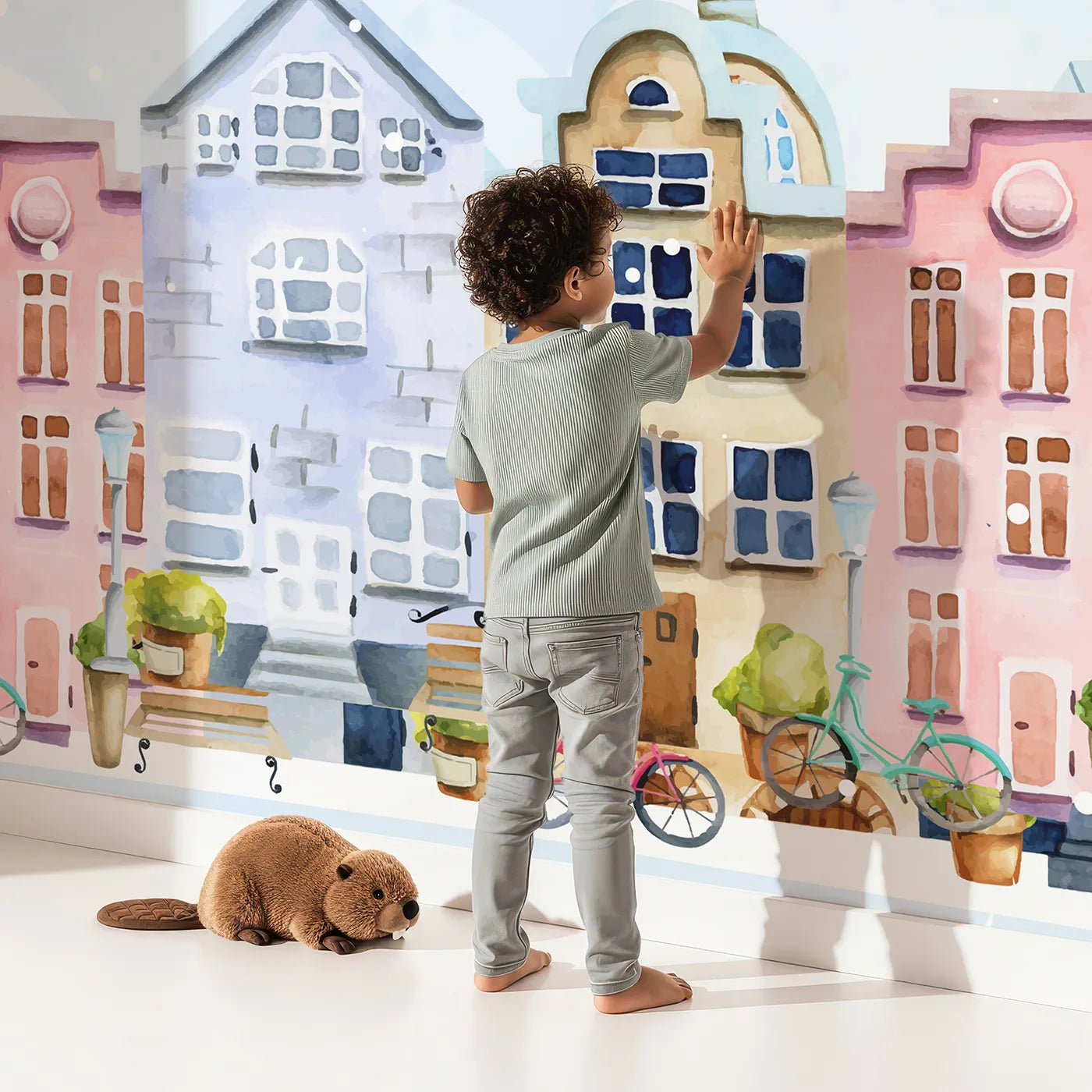 Child in front of Whimsy Tots Animal Balloon Ride Over Town Wall Mural with animal, balloon, town, house, cute, safari, sky, whimsical in design.