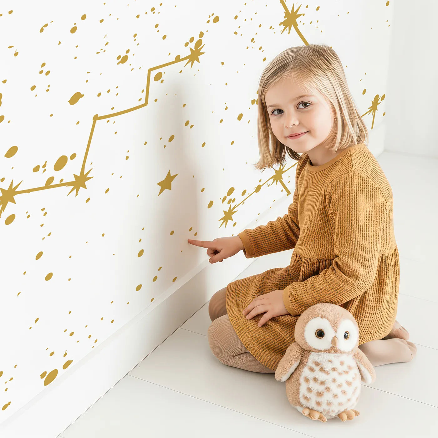 Child in front of Whimsy Tots Golden Constellations Wall Mural with star, constellation, space, gold, planet, galaxy, celestial, zodiac in design.