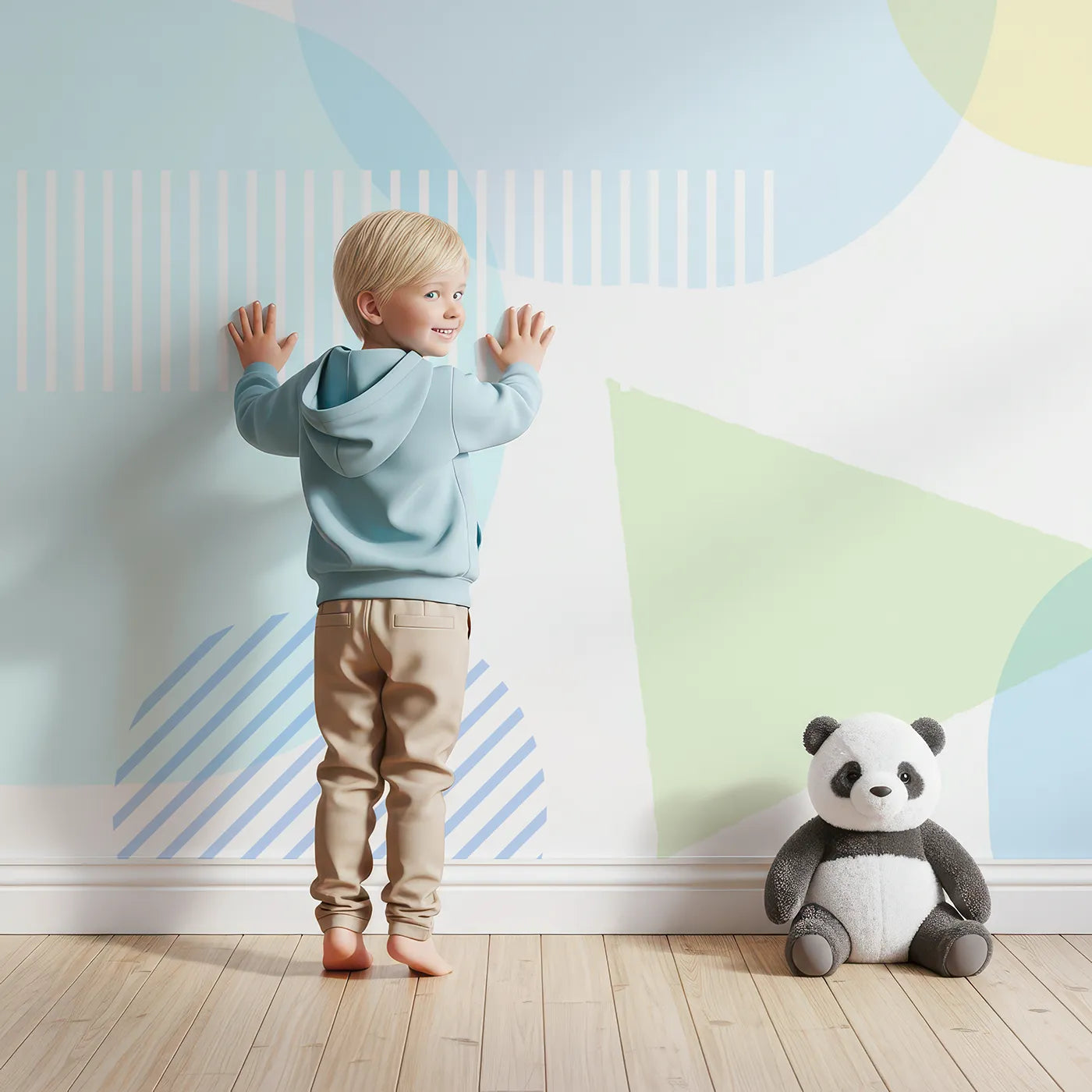 Child in front of Whimsy Tots Pastel Geometric Play Wall Mural with geometric, shape, pastel, circle, triangle, blue, yellow, modern in design.