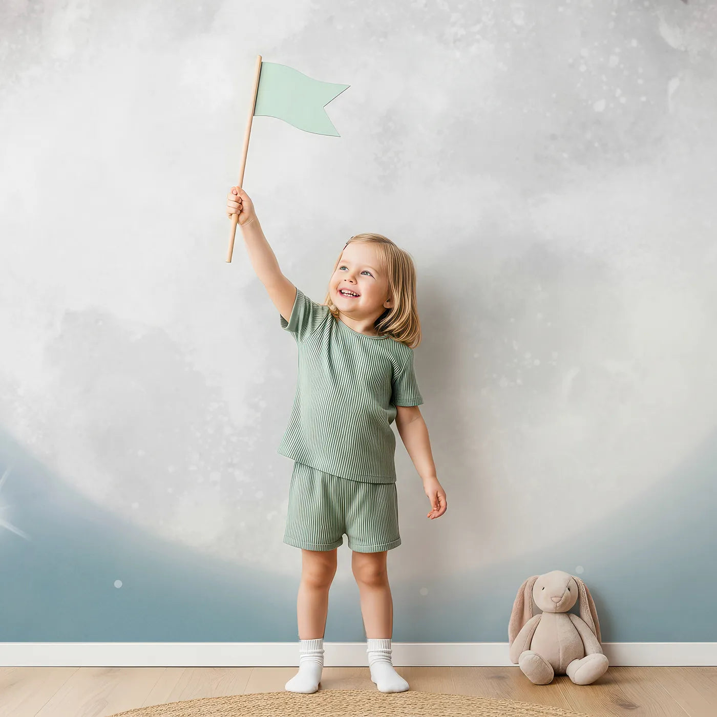 Child in front of Whimsy Tots Koala on the Moon Wall Mural with koala, moon, sleep, star, sparkle, cute, nursery, blue in design.