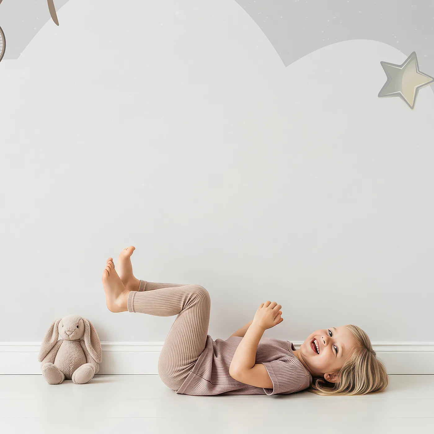 Child in front of Whimsy Tots Vintage Night Flight Wall Mural with airplane, balloon, vintage, night, moon, star, retro, gray in design.