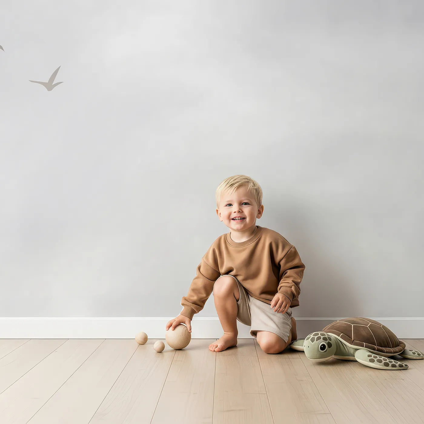 Child in front of Whimsy Tots Springtime Balloon Festival Wall Mural with balloon, hot air balloon, animal, blossom, sky, vintage, neutral, cute in design.