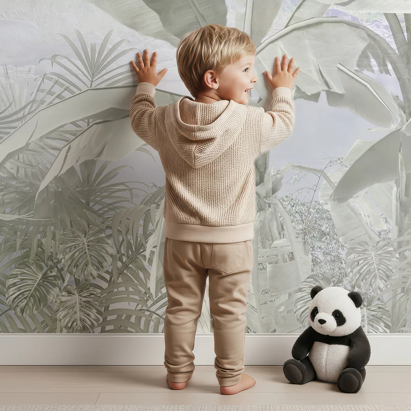 Child in front of Whimsy Tots Misty Gray Jungle Wall Mural with jungle, tropical, gray, mist, monochrome, forest, palm tree, black and white in design.
