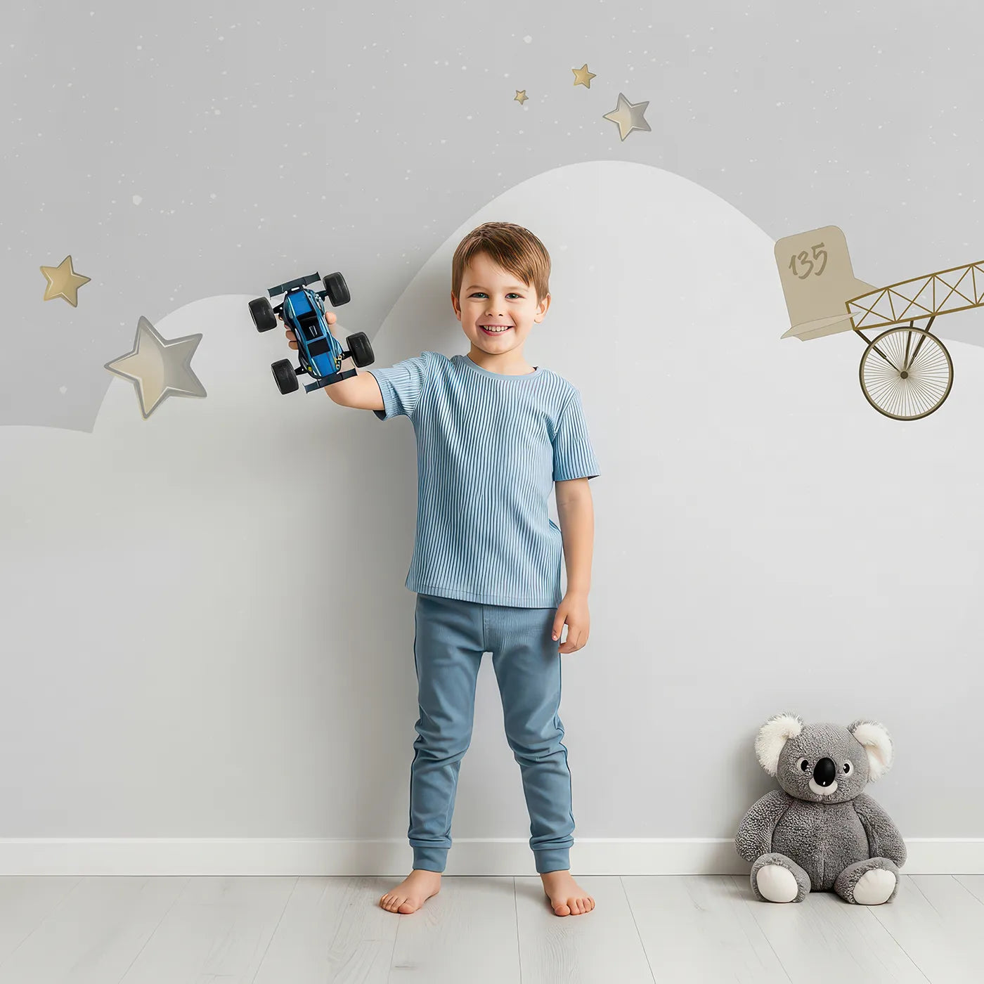 Child in front of Whimsy Tots Gray Night Flight Wall Mural with airplane, balloon, vintage, night, moon, star, gray, retro in design.