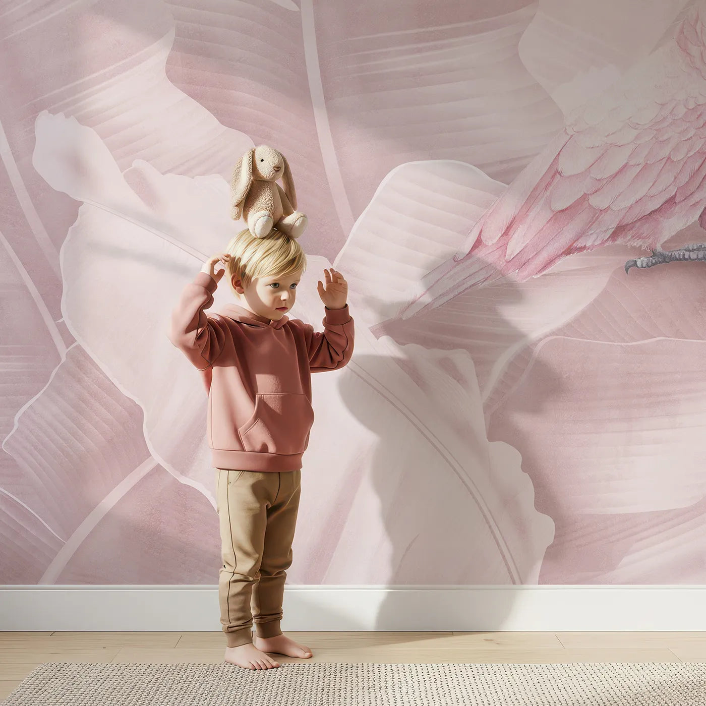 Child in front of Whimsy Tots Pink Parrot Jungle Wall Mural with parrot, pink, tropical, jungle, leaf, bird, romantic, monochromatic in design.