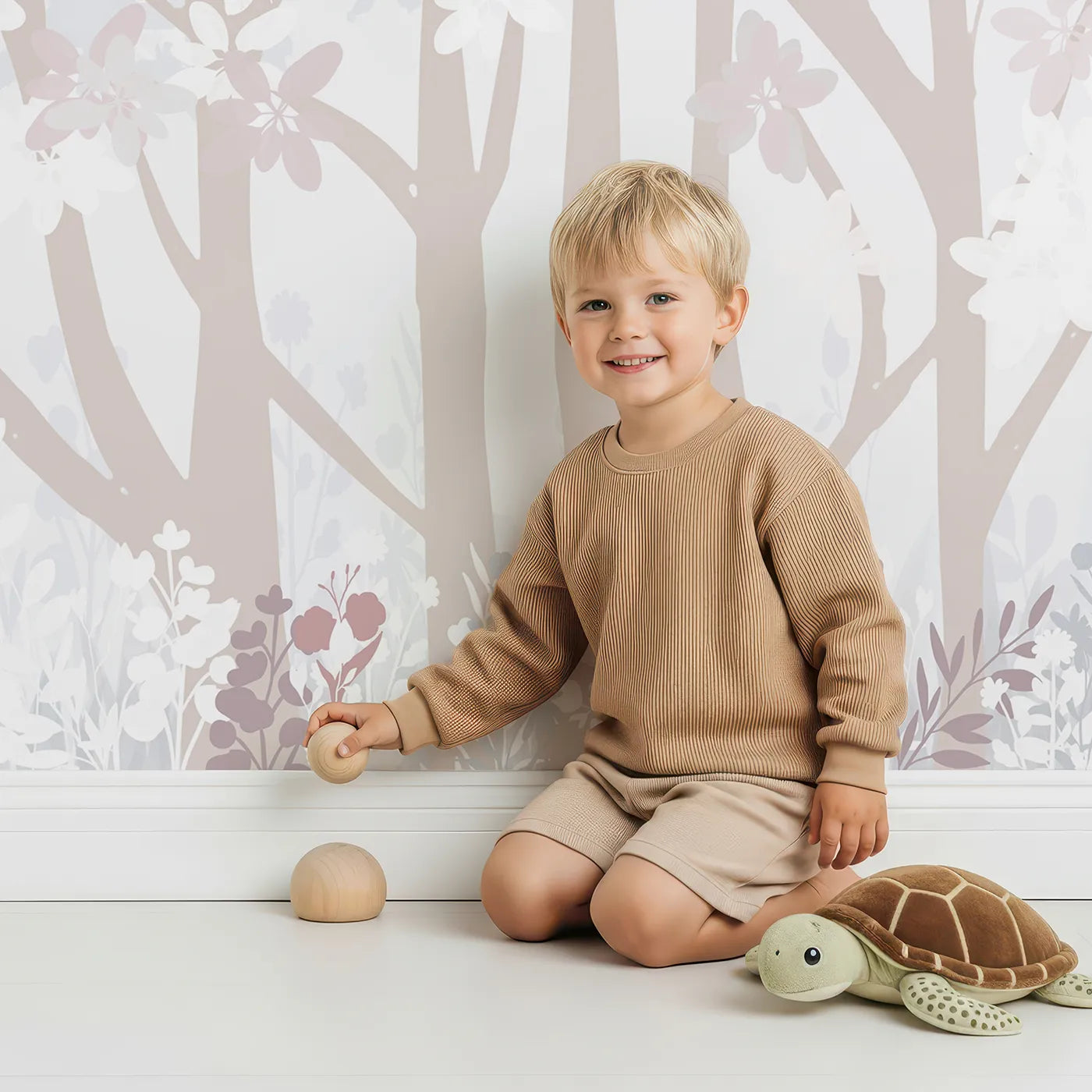 Child in front of Whimsy Tots Misty Blossom Forest Wall Mural with forest, blossom, mist, pink, gray, abstract, romantic, tree in design.