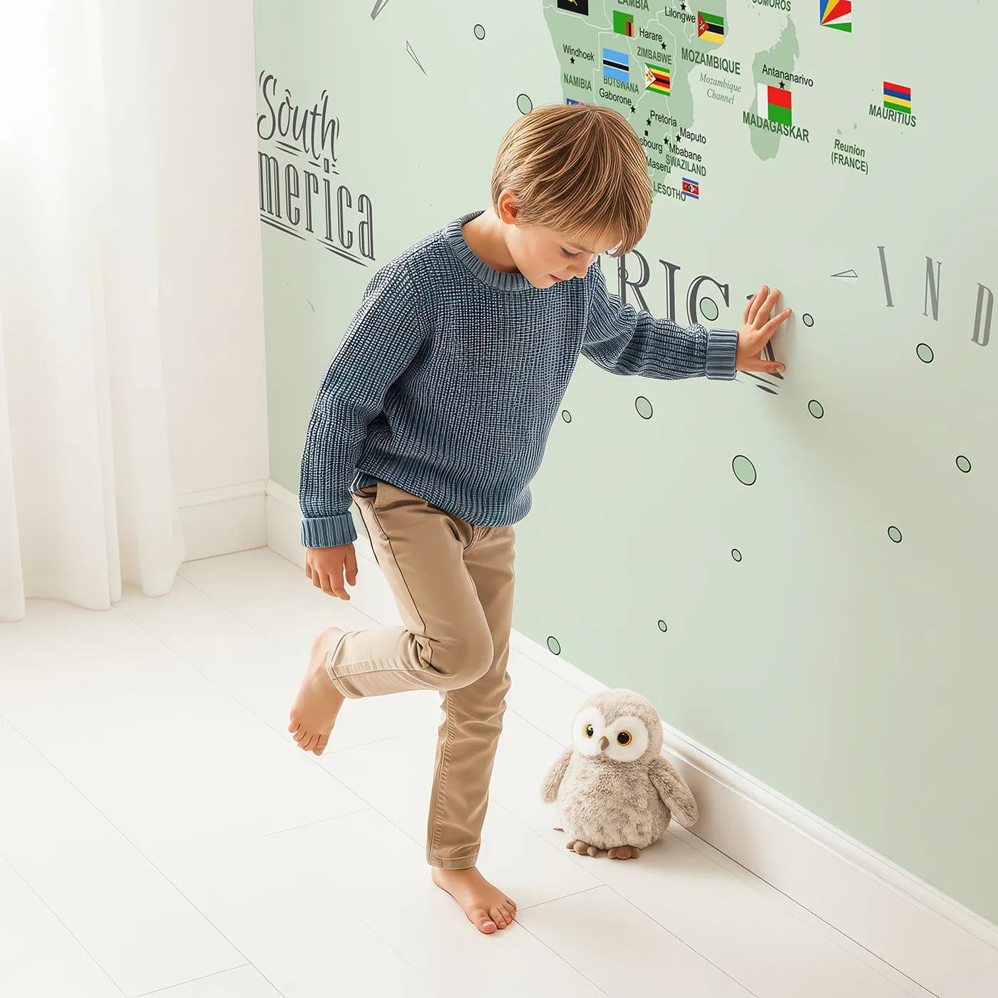 Child in front of Whimsy Tots World Map with Flags and Pins Wall Mural with map, world, flag, country, educational, travel, pin, political in design.