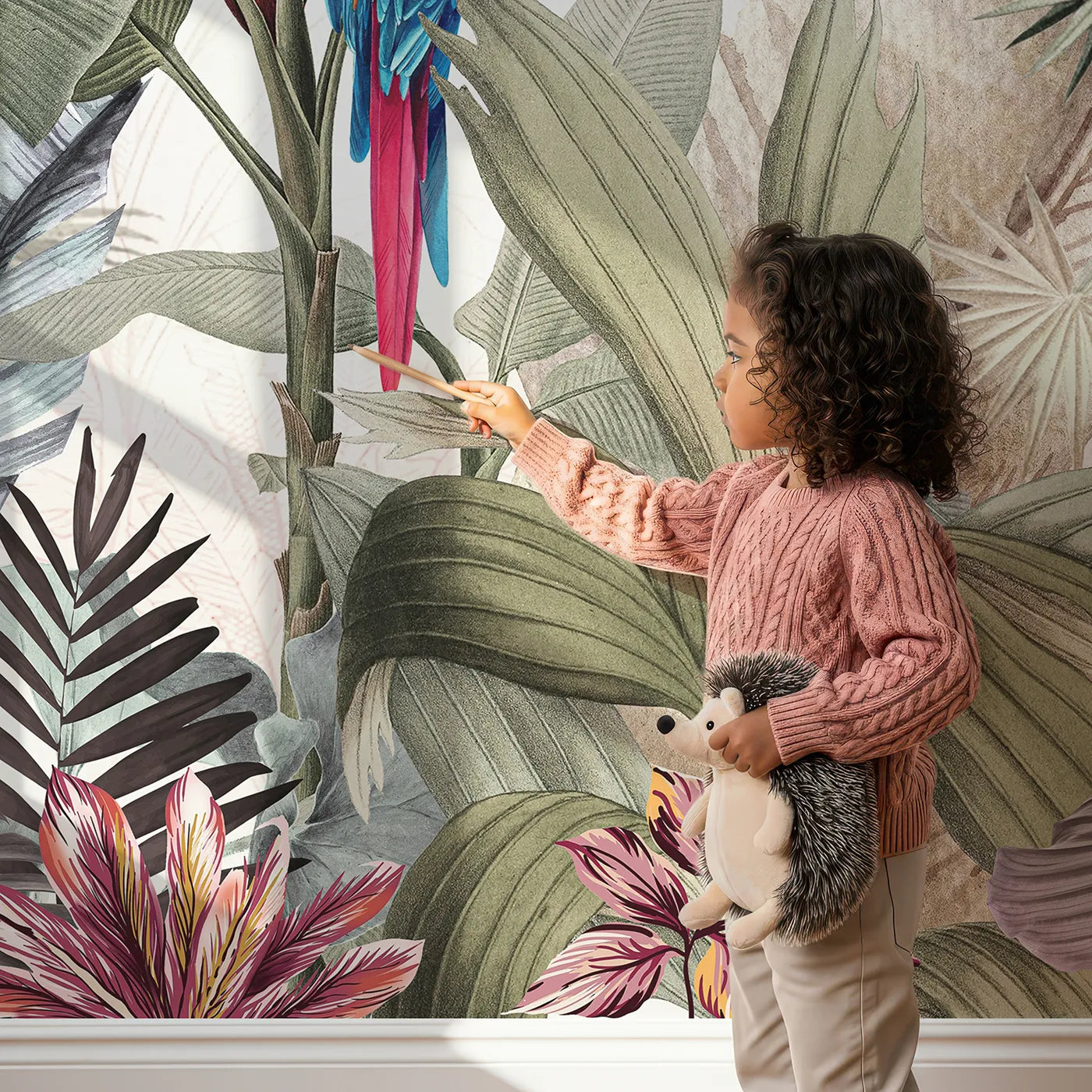 Child in front of Whimsy Tots Tropical Parrot Paradise Wall Mural with parrot, macaw, tropical, jungle, bird, flower, vibrant, realistic in design.