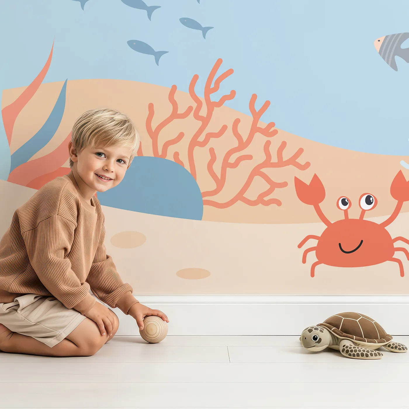 Child in front of Whimsy Tots Happy Whale and Friends Wall Mural with whale, ocean, sea, cute, cartoon, starfish, crab, underwater in design.