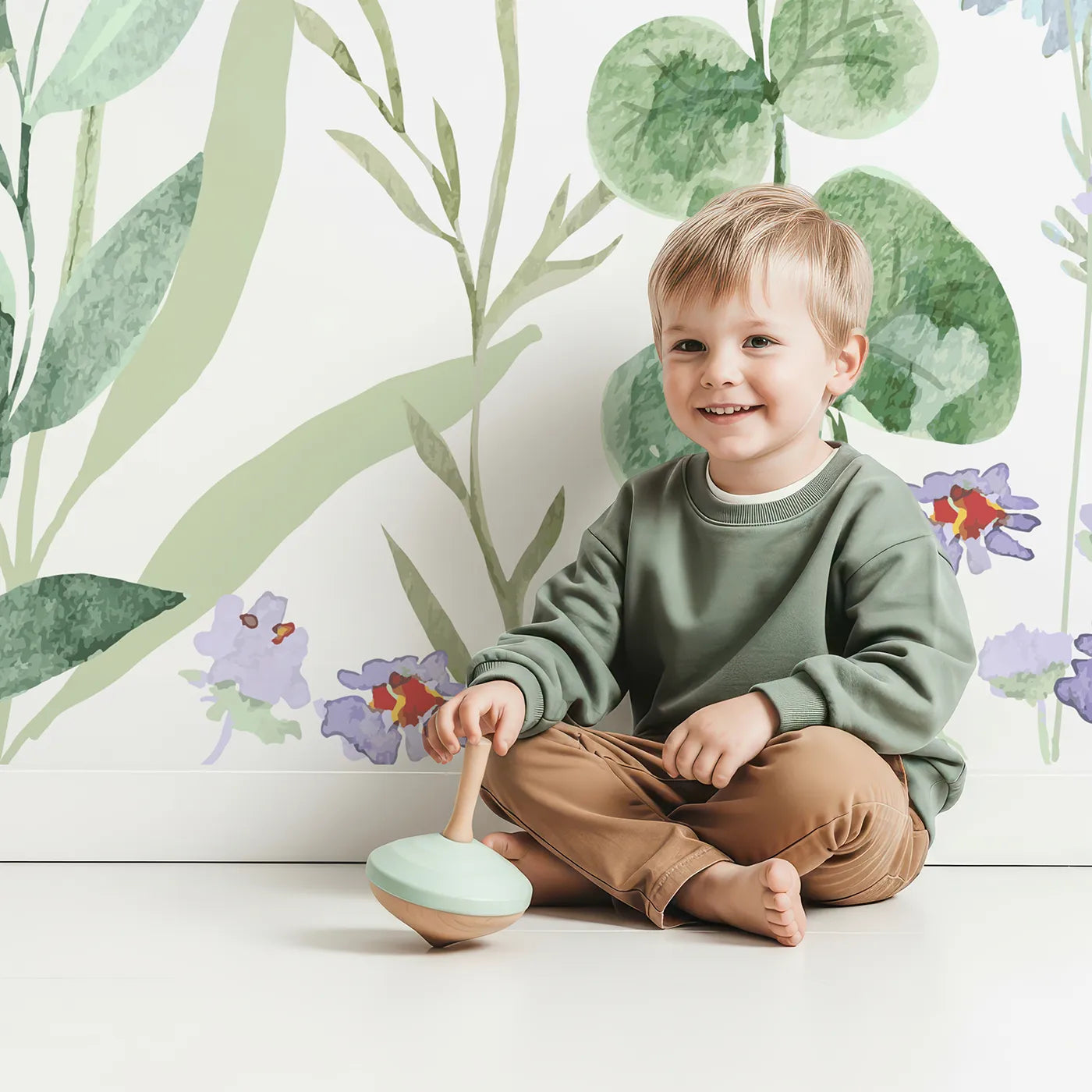 Child in front of Whimsy Tots Watercolor Wildflower Meadow Wall Mural with flower, wildflower, watercolor, floral, pattern, colorful, pastel, botanical in design.