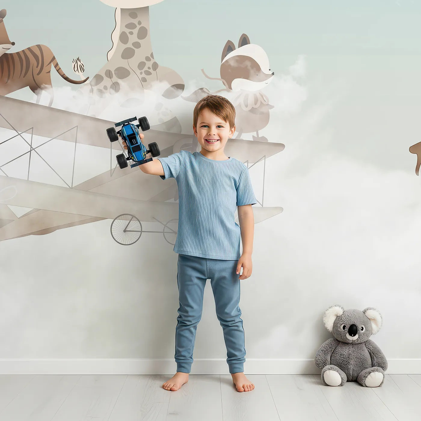 Child in front of Whimsy Tots Safari Sky High Wall Mural with animal, safari, airplane, balloon, cute, vintage, sky, whimsical in design.