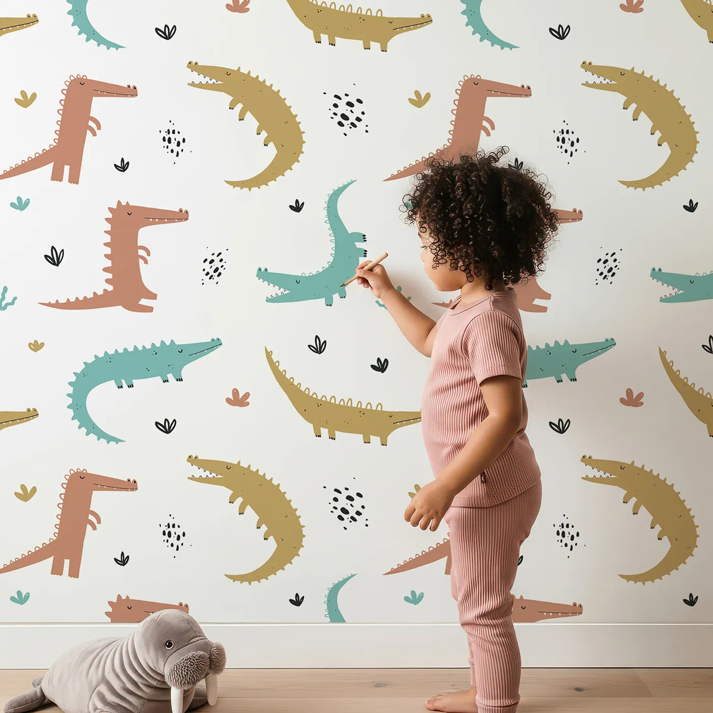 Lovely child standing in front of Whimsy Tots Snappy Crocodile Friends Wallpaper with crocodile, alligator, jungle, animal, modern in design.