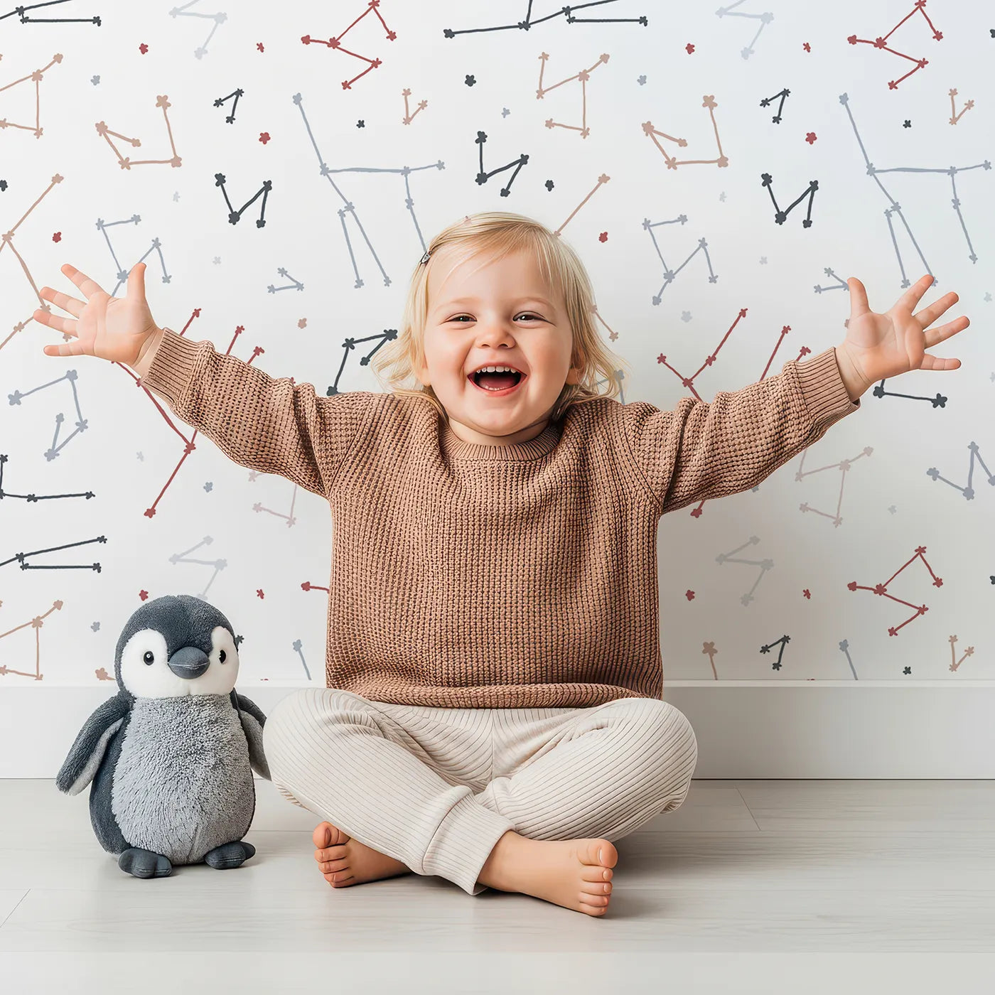 Lovely child standing in front of Whimsy Tots Abstract Star Constellation Wallpaper with star, constellation, space, abstract, modern in design.