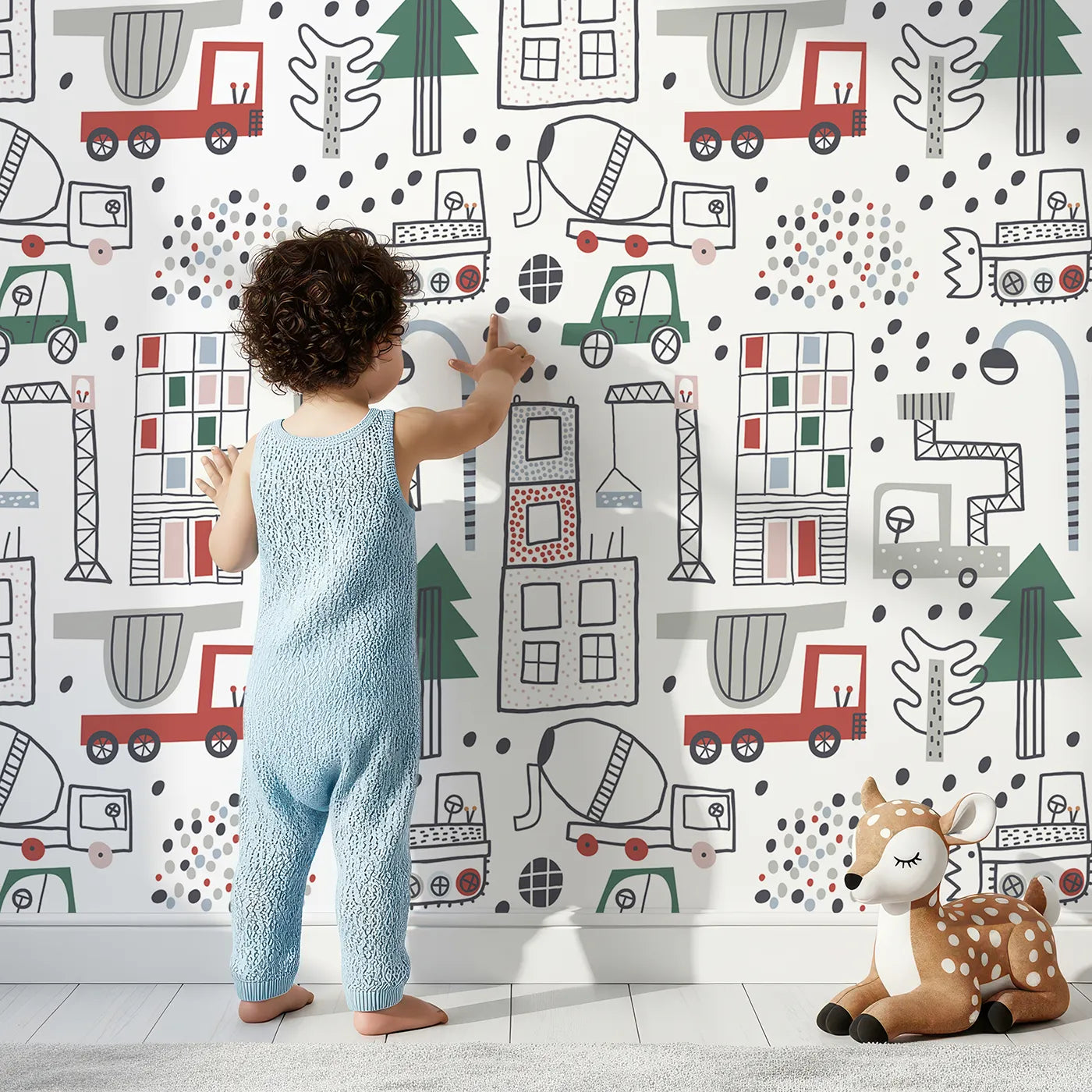 Lovely child standing in front of Whimsy Tots Doodle Construction City Wallpaper with city, construction, truck, building, doodle in design.