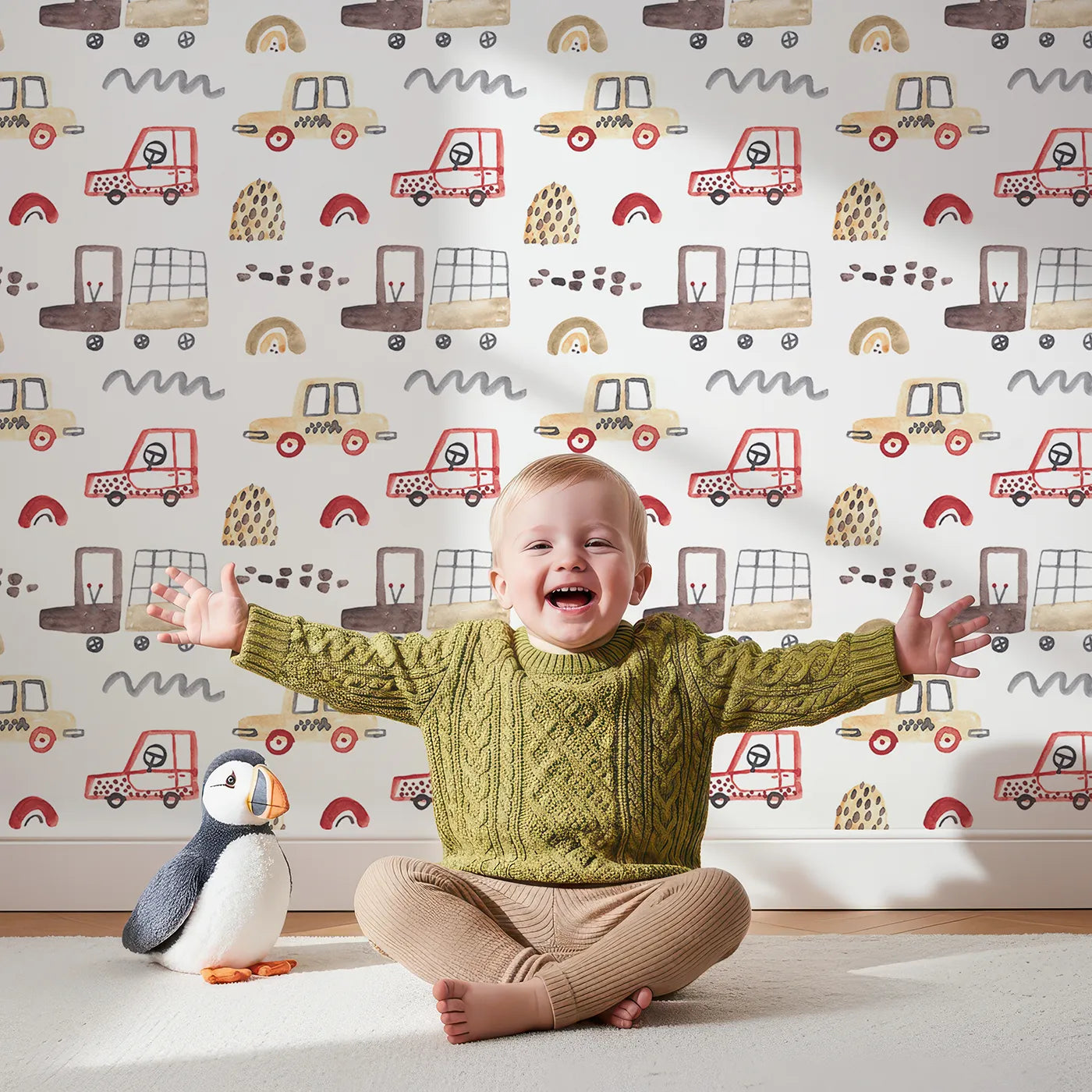 Lovely child standing in front of Whimsy Tots Watercolor Car Friends Wallpaper in Brown with car, truck, watercolor, boho, road in design.