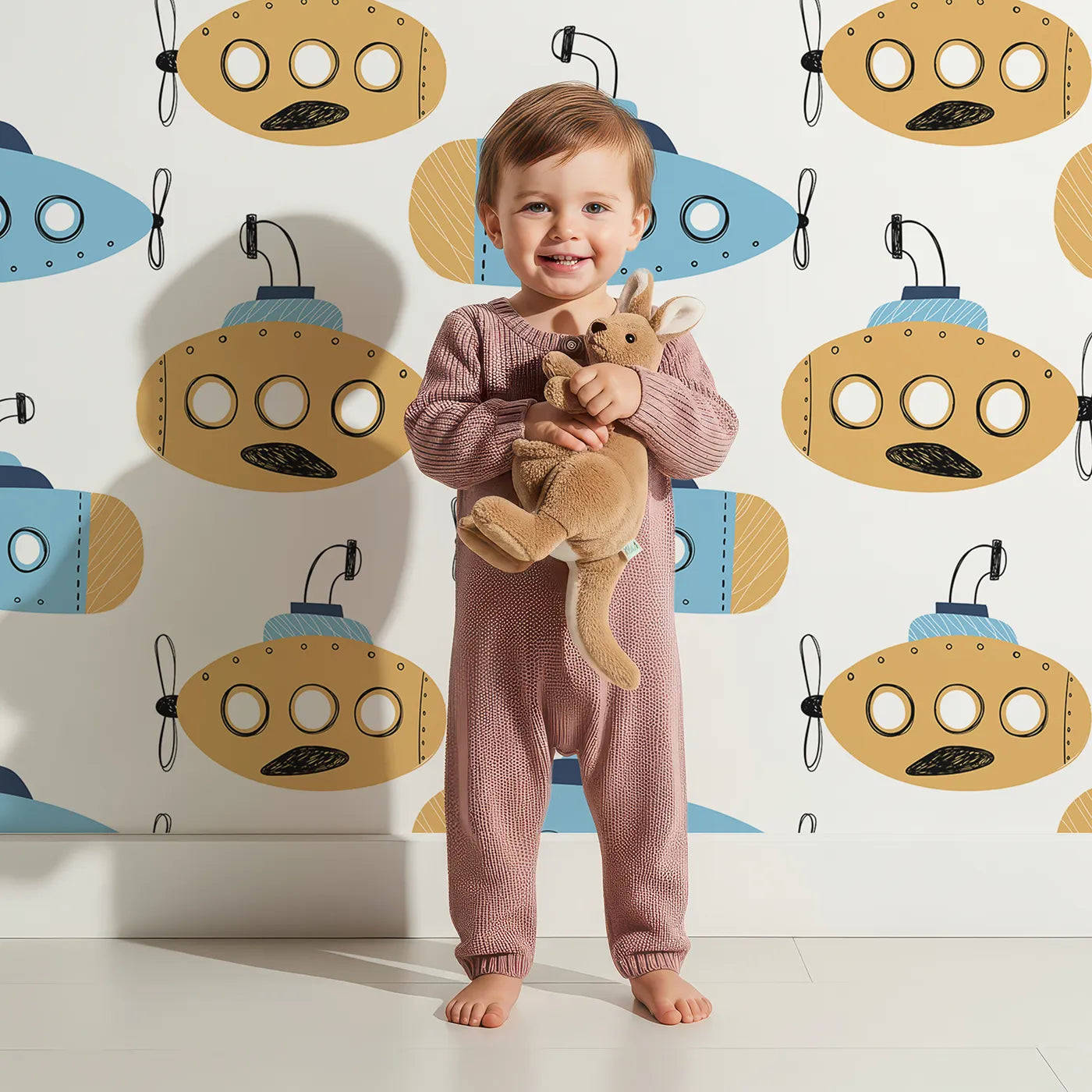 Lovely child standing in front of Whimsy Tots Quirky Submarine Voyage Wallpaper with submarine, ocean, sea, doodle, boat in design.