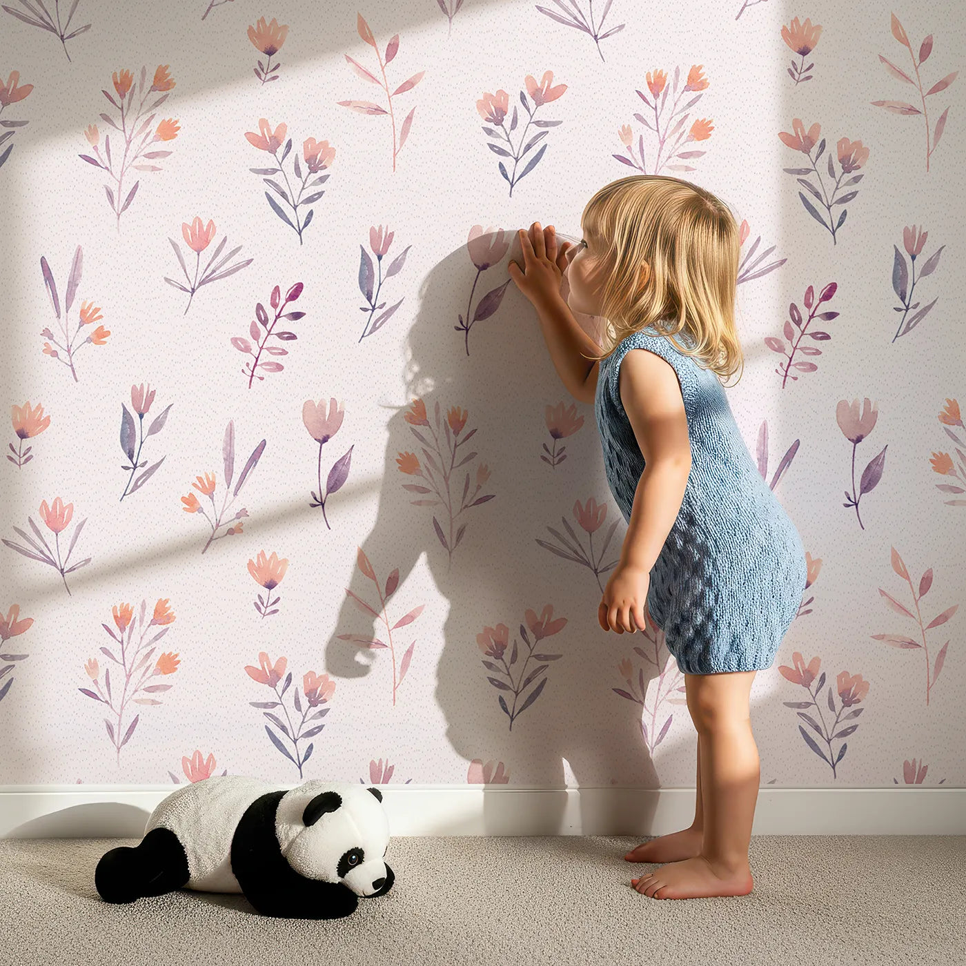 Lovely child standing in front of Whimsy Tots Pastel Watercolor Sprigs Wallpaper with flower, floral, watercolor, pastel, botanical in design.
