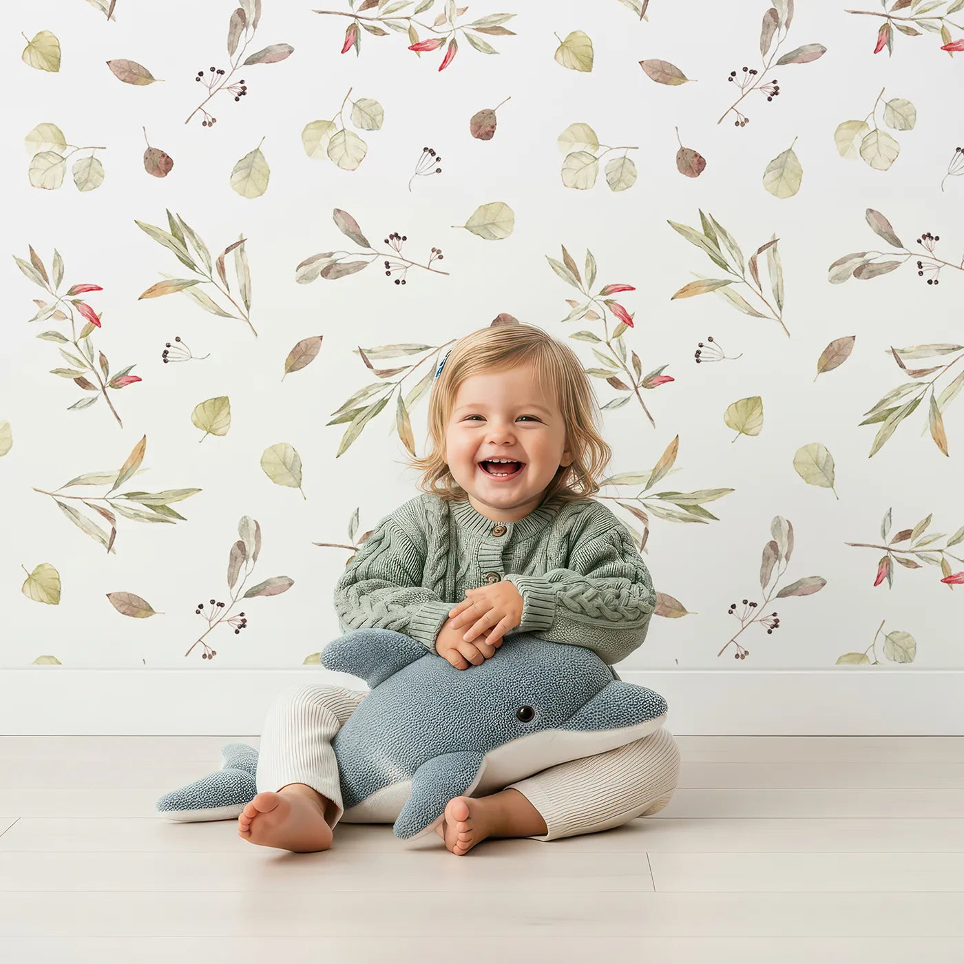 Lovely child standing in front of Whimsy Tots Autumn Eucalyptus Leaves Wallpaper with leaf, botanical, watercolor, autumn, eucalyptus in design.