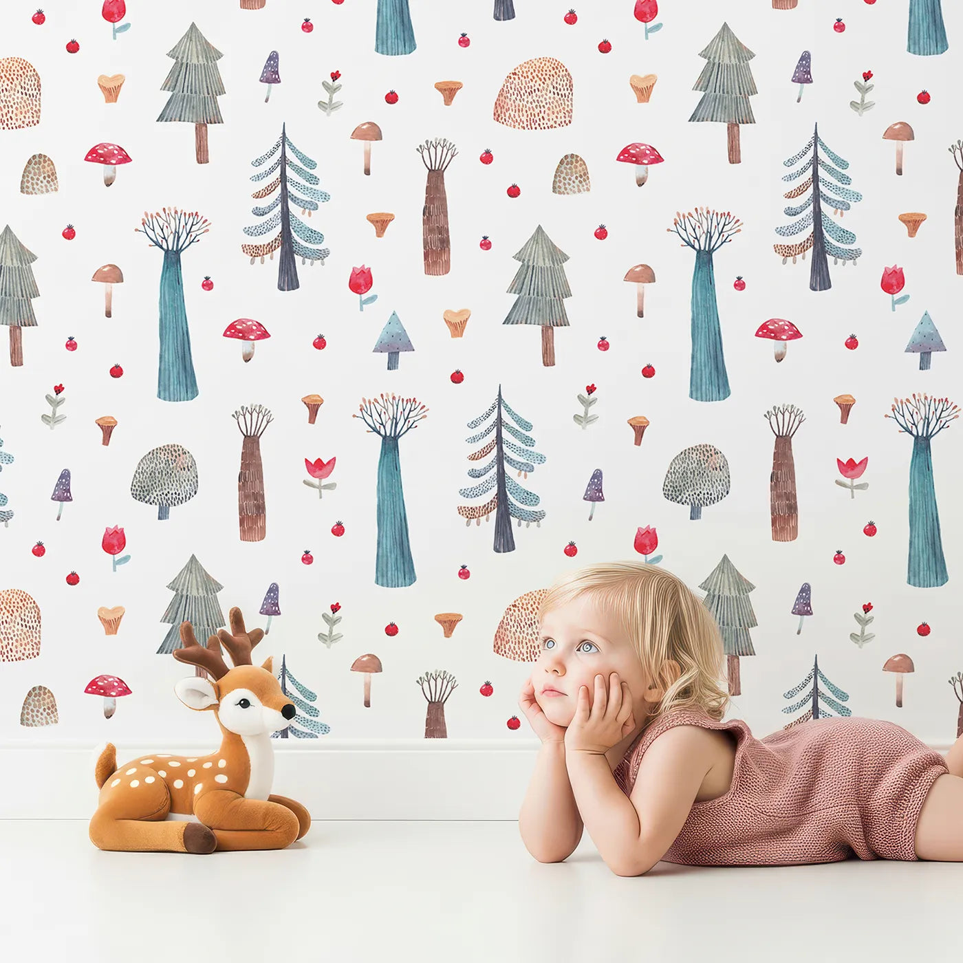 Lovely child standing in front of Whimsy Tots Whimsical Watercolor Forest Wallpaper with forest, tree, mushroom, watercolor, artistic in design.