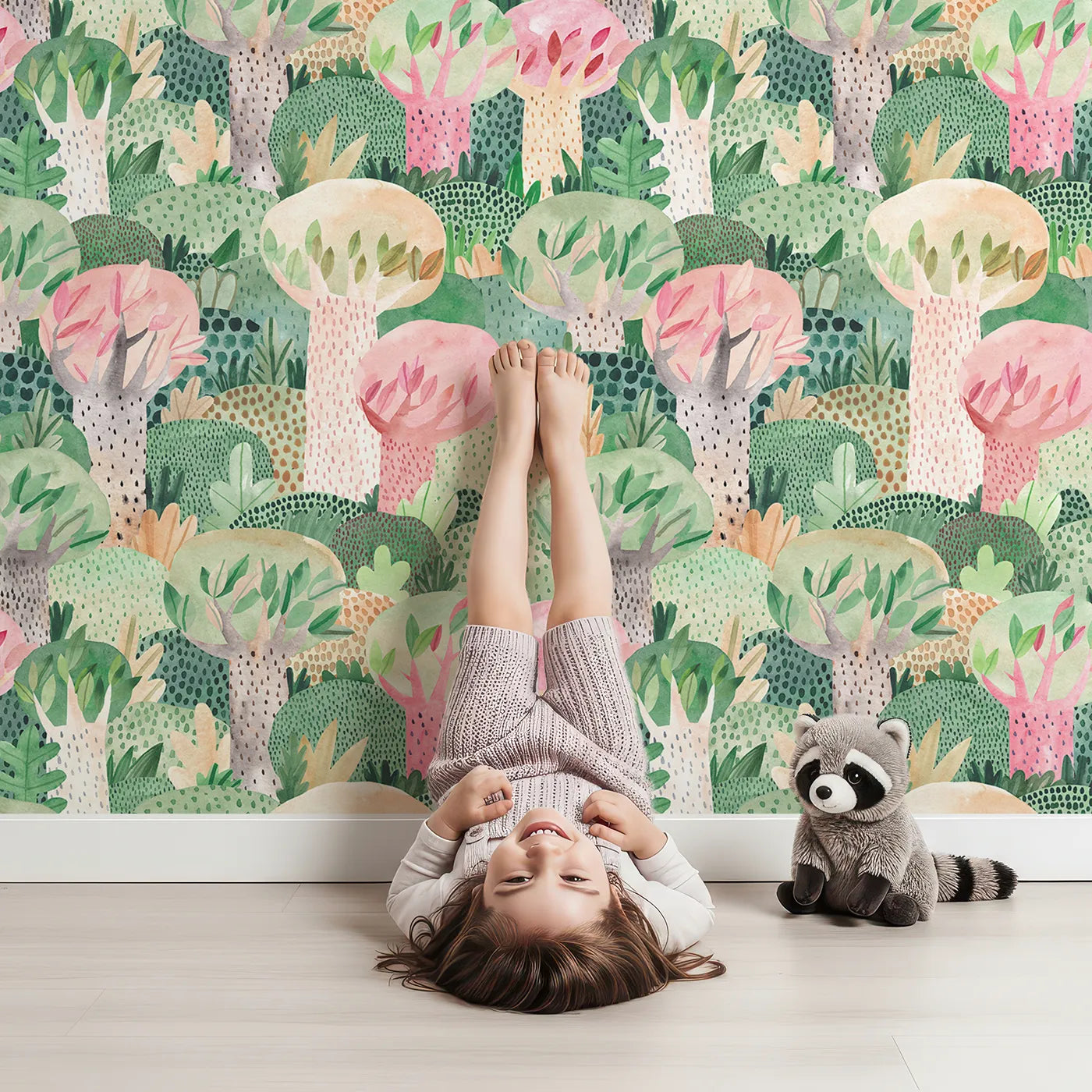 Lovely child standing in front of Whimsy Tots Painted Forest Canopy Wallpaper with forest, tree, watercolor, abstract, pink in design.