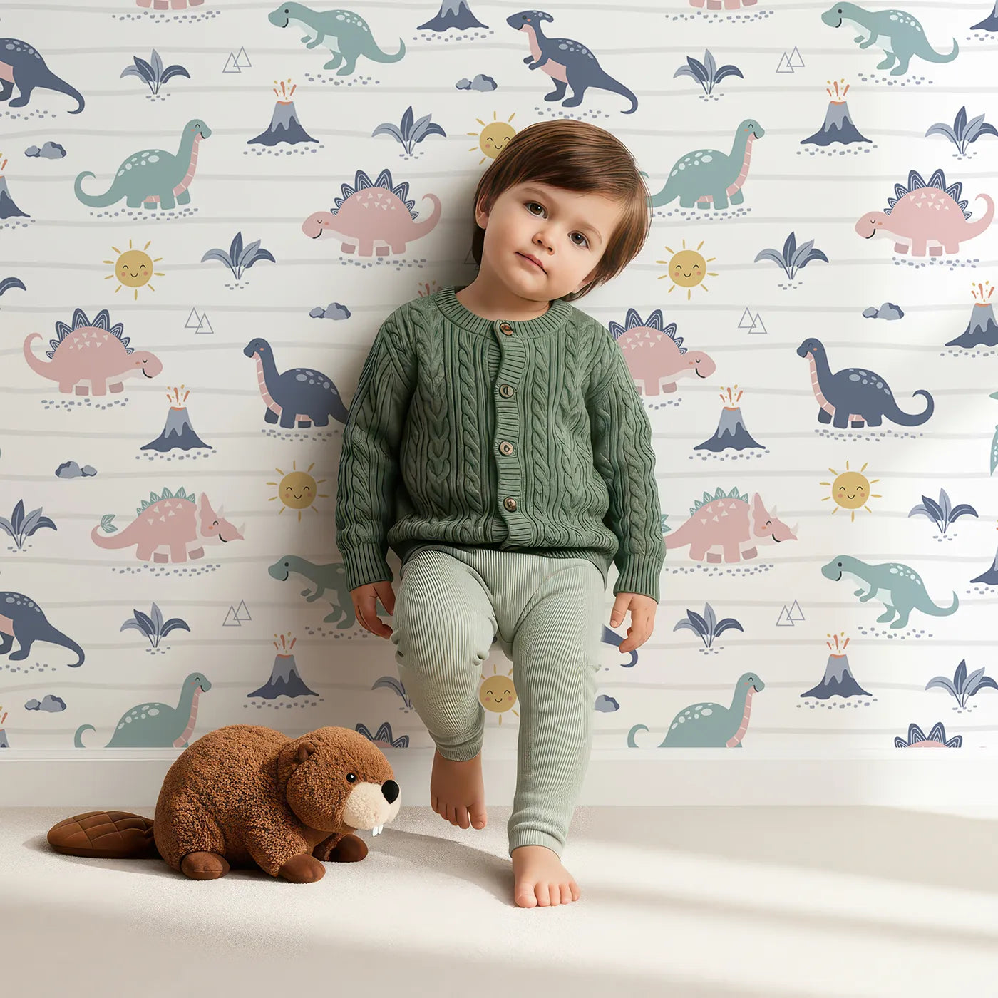 Lovely child standing in front of Whimsy Tots Pastel Dino Parade Wallpaper with dinosaur, pastel, volcano, sun, cute in design.