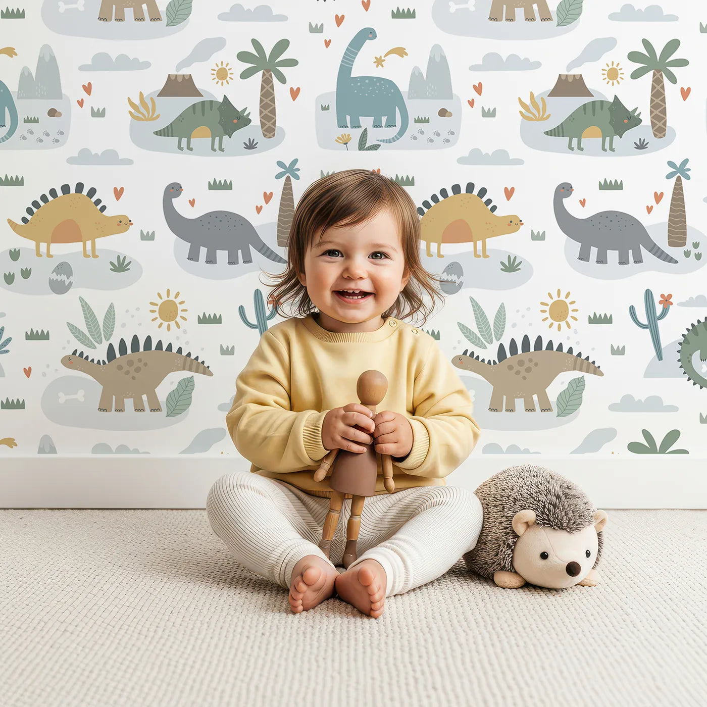 Lovely child standing in front of Whimsy Tots Playful Dinosaur Land Wallpaper with dinosaur, cute, volcano, sun, prehistoric in design.