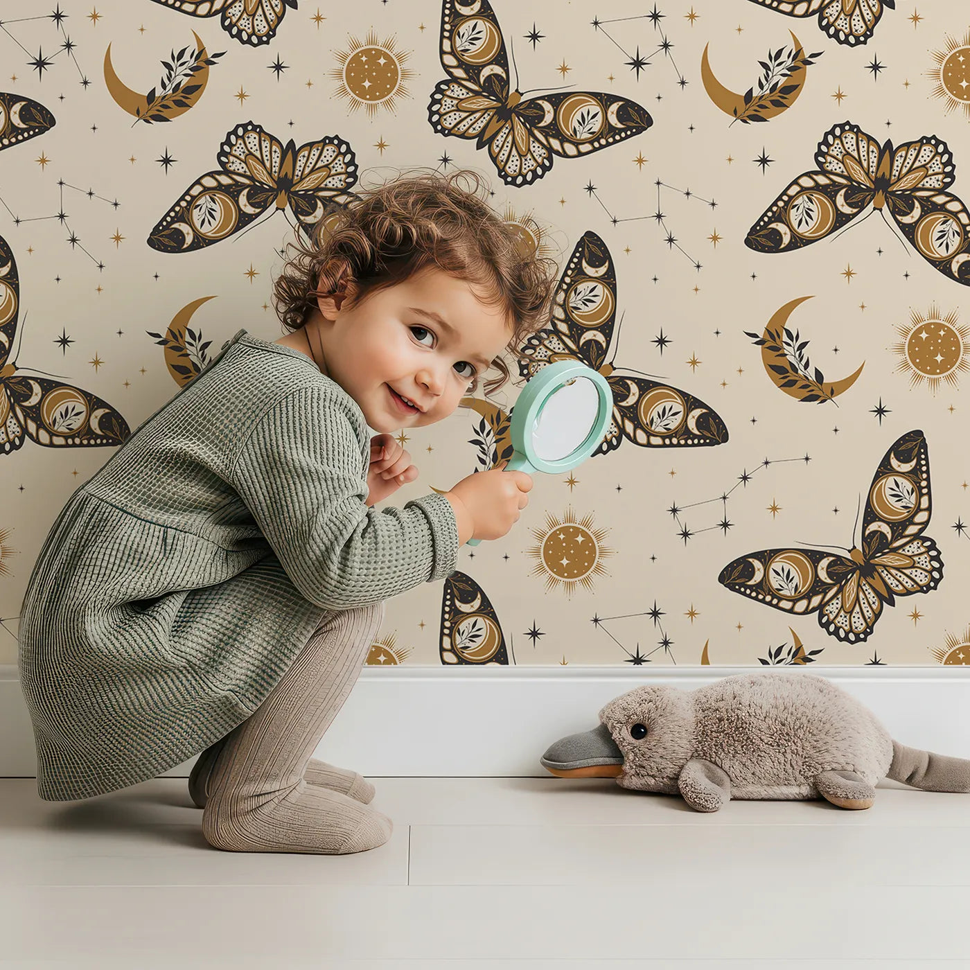 Lovely child standing in front of Whimsy Tots Celestial Moth and Moon Wallpaper with moth, butterfly, moon, star, celestial in design.
