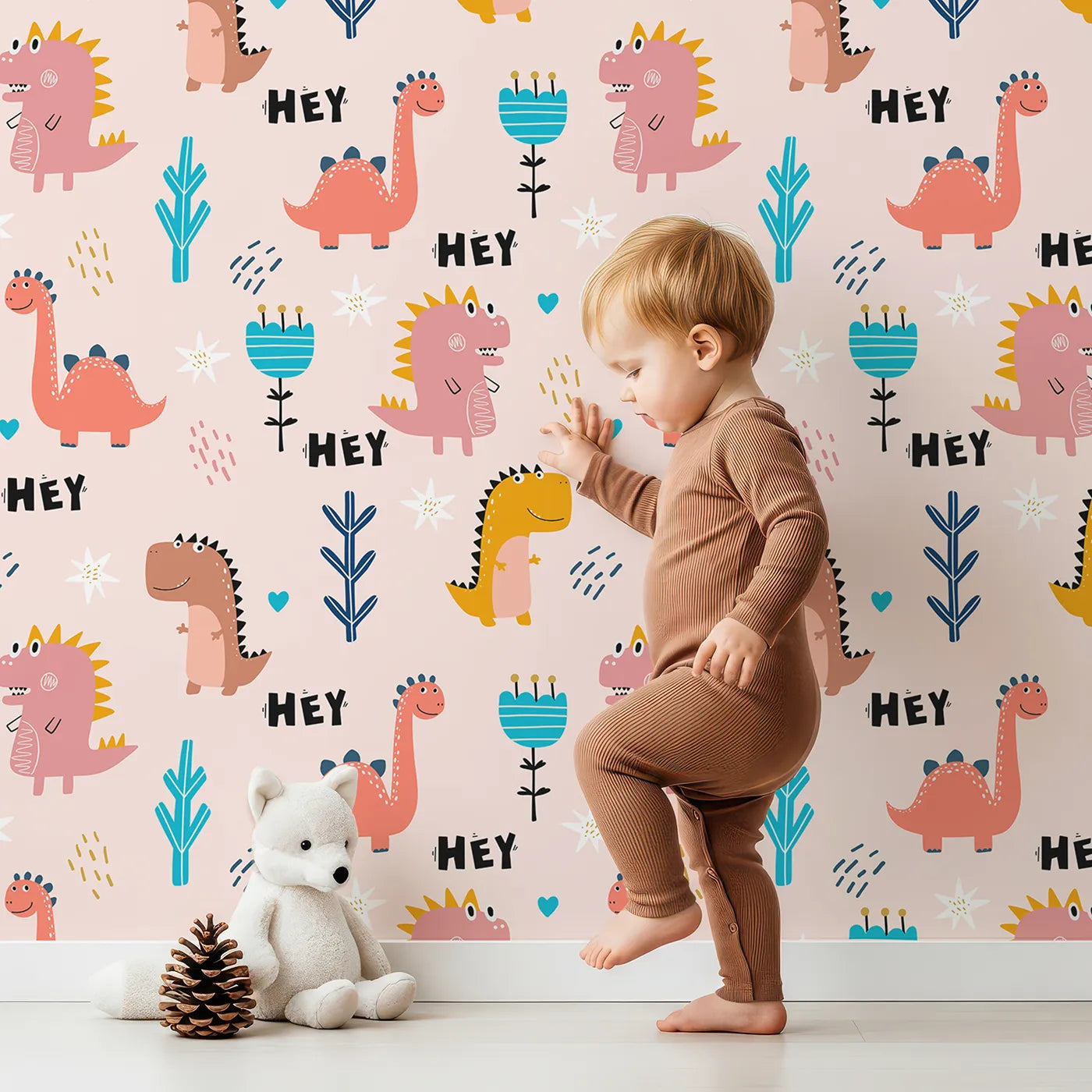 Lovely child standing in front of Whimsy Tots Friendly Dino Hey Day Wallpaper with dinosaur, hey, cute, pink, cartoon in design.