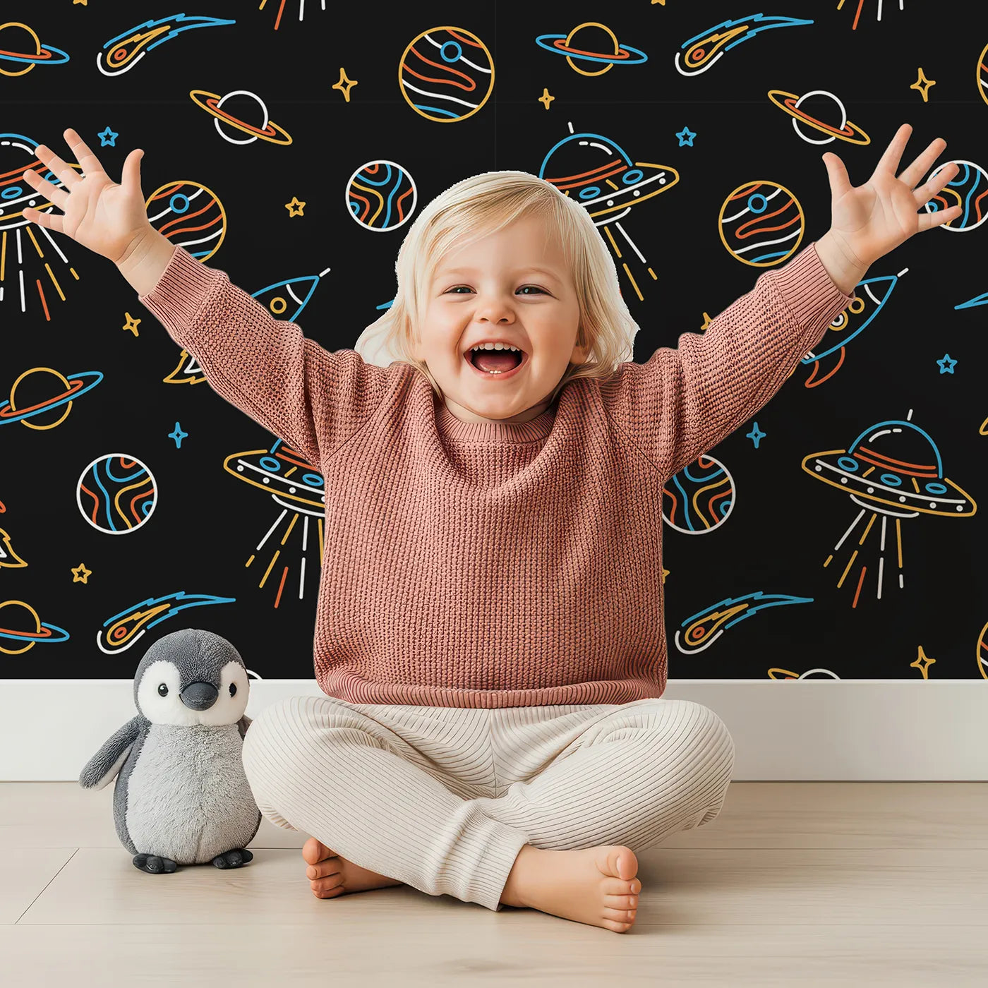 Lovely child standing in front of Whimsy Tots Neon Space Voyage Wallpaper with space, neon, rocket, ufo, planet in design.