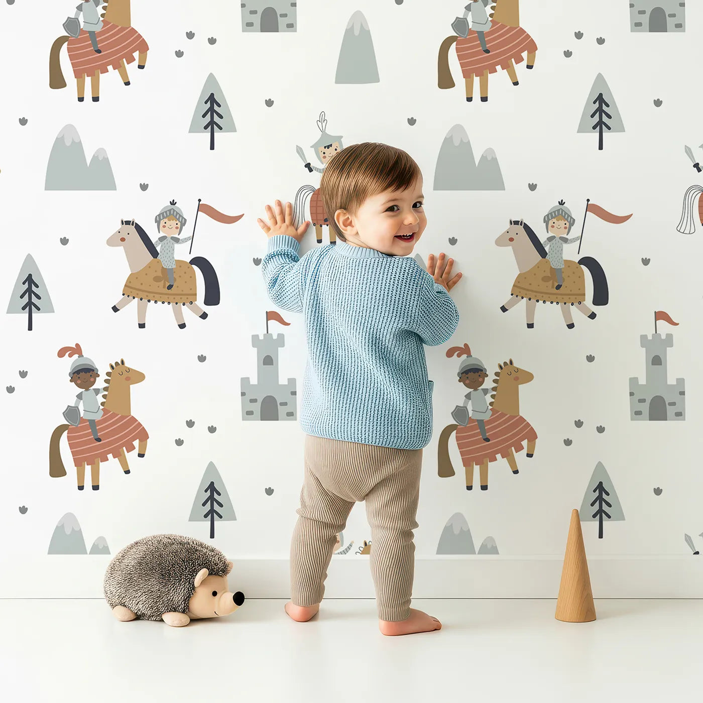 Lovely child standing in front of Whimsy Tots Brave Knights of the Kingdom Wallpaper with knight, horse, castle, medieval, hero in design.