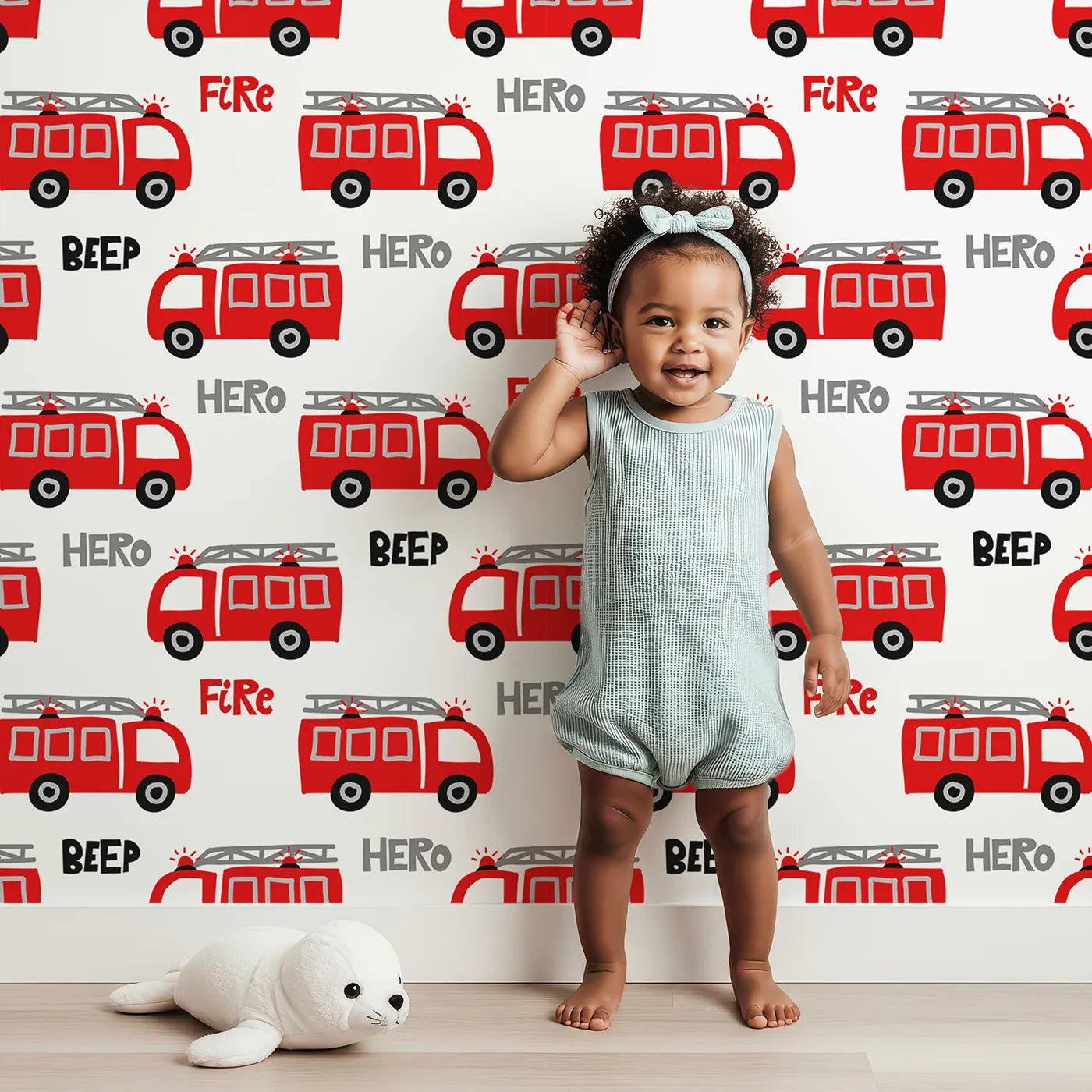 Lovely child standing in front of Whimsy Tots Fire Truck Hero Wallpaper with fire truck, hero, red, vehicle, beep in design.