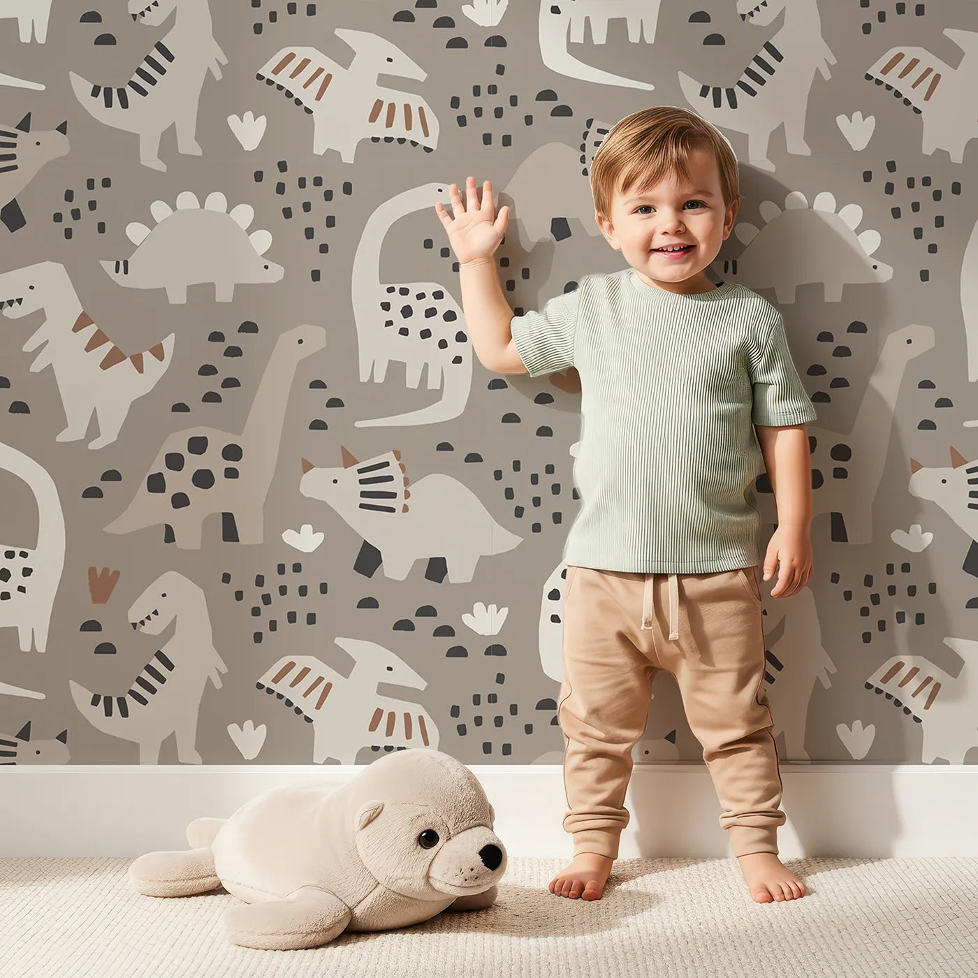 Lovely child standing in front of Whimsy Tots Paper Cut Dino Land Wallpaper in Gray with dinosaur, paper cut, modern, gray, silhouette in design.