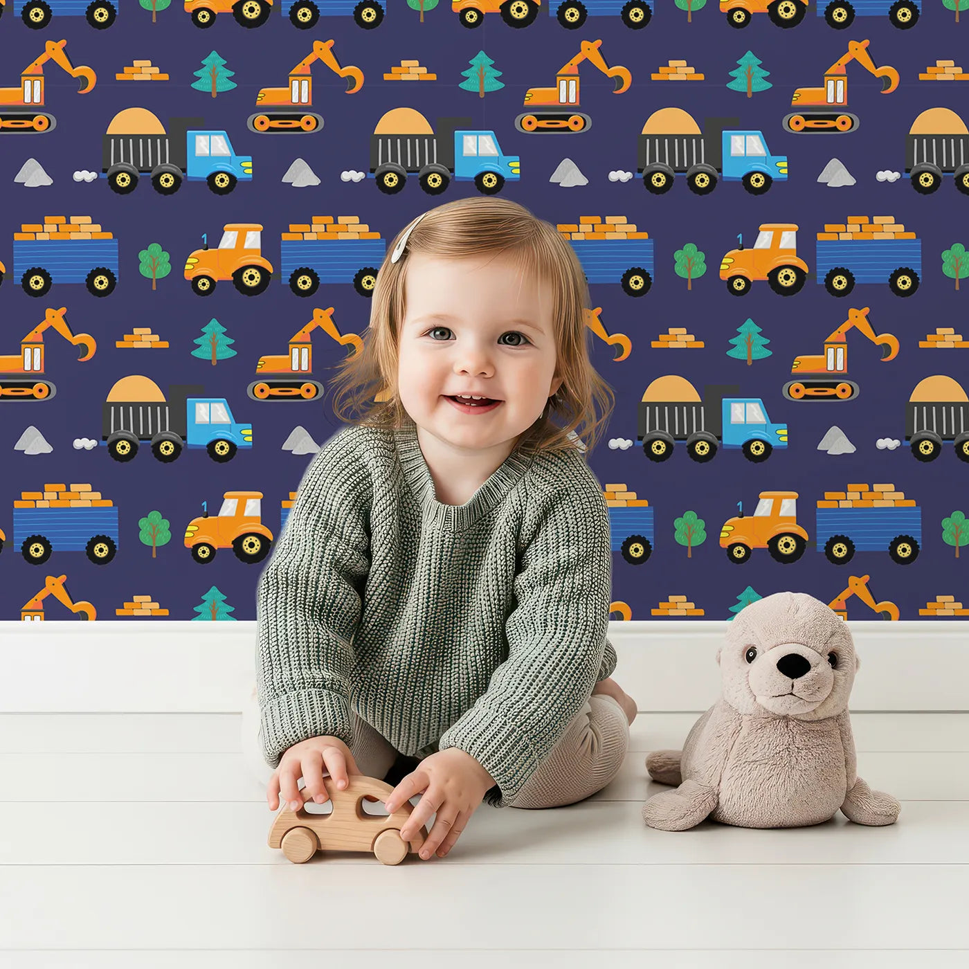 Lovely child standing in front of Whimsy Tots Bright Construction Zone Wallpaper with construction, truck, excavator, tractor, colorful in design.