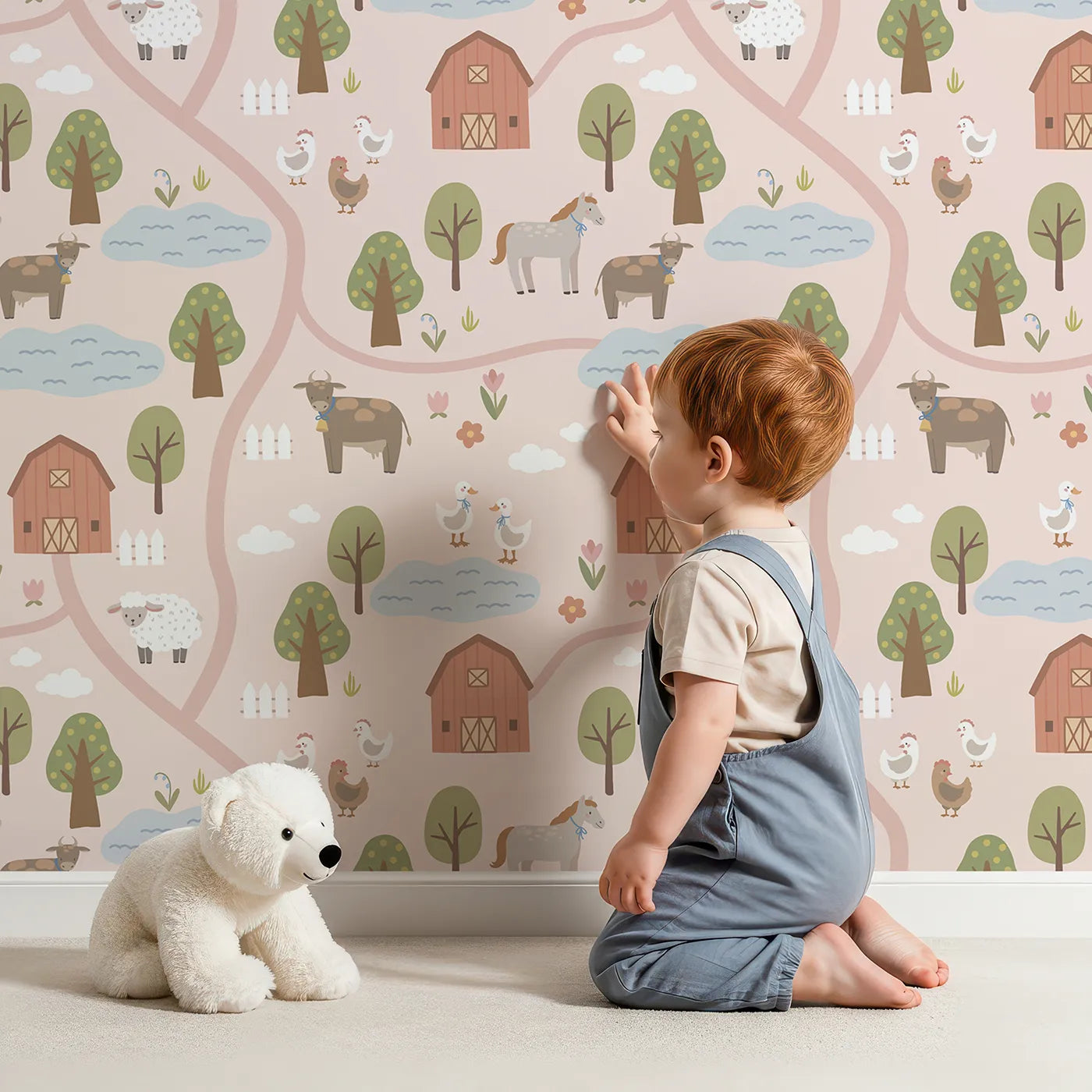 Lovely child standing in front of Whimsy Tots Country Farm Map Wallpaper in Pink with farm, map, animal, cow, barn in design.