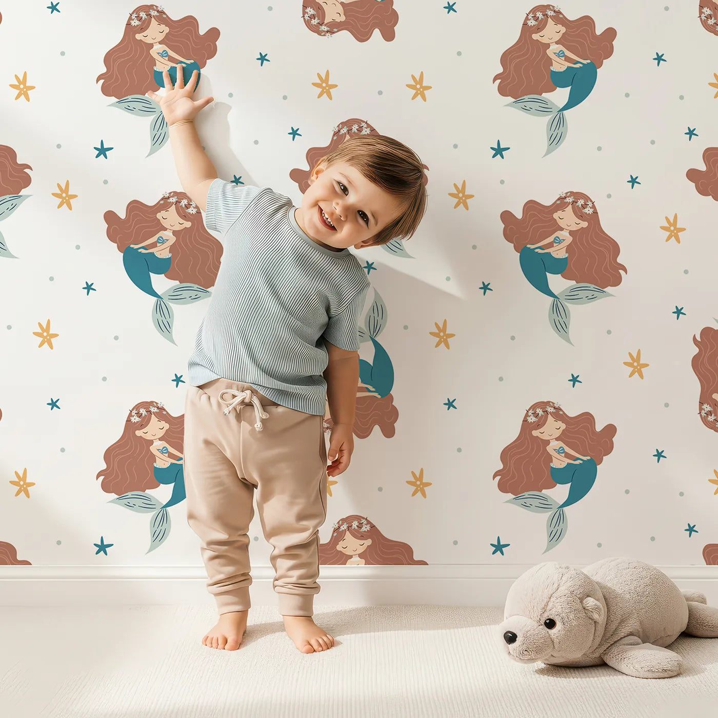 Lovely child standing in front of Whimsy Tots Boho Mermaid Dreams Wallpaper with mermaid, boho, starfish, sea, ocean in design.