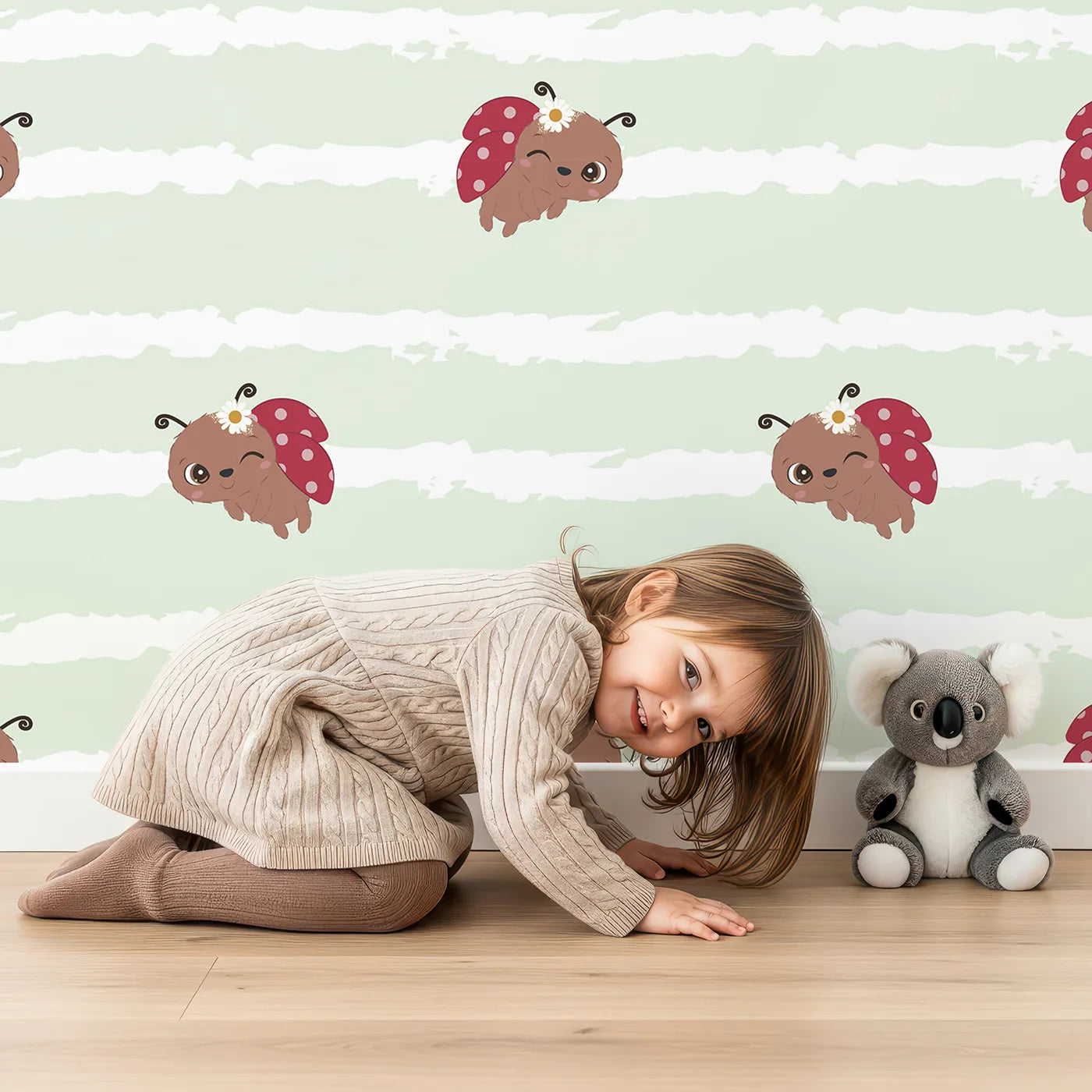 Lovely child standing in front of Whimsy Tots Winkie the Ladybug Wallpaper in Green with ladybug, stripe, flower, bug in design.