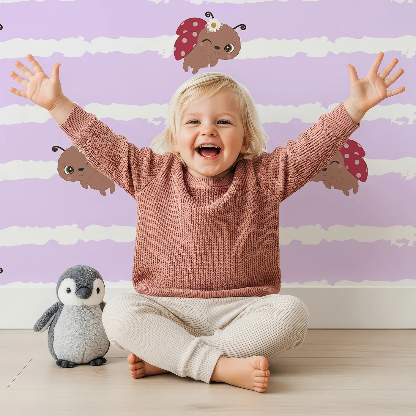 Lovely child standing in front of Whimsy Tots Winkie the Ladybug Wallpaper in Purple with ladybug, stripe, flower, bug in design.