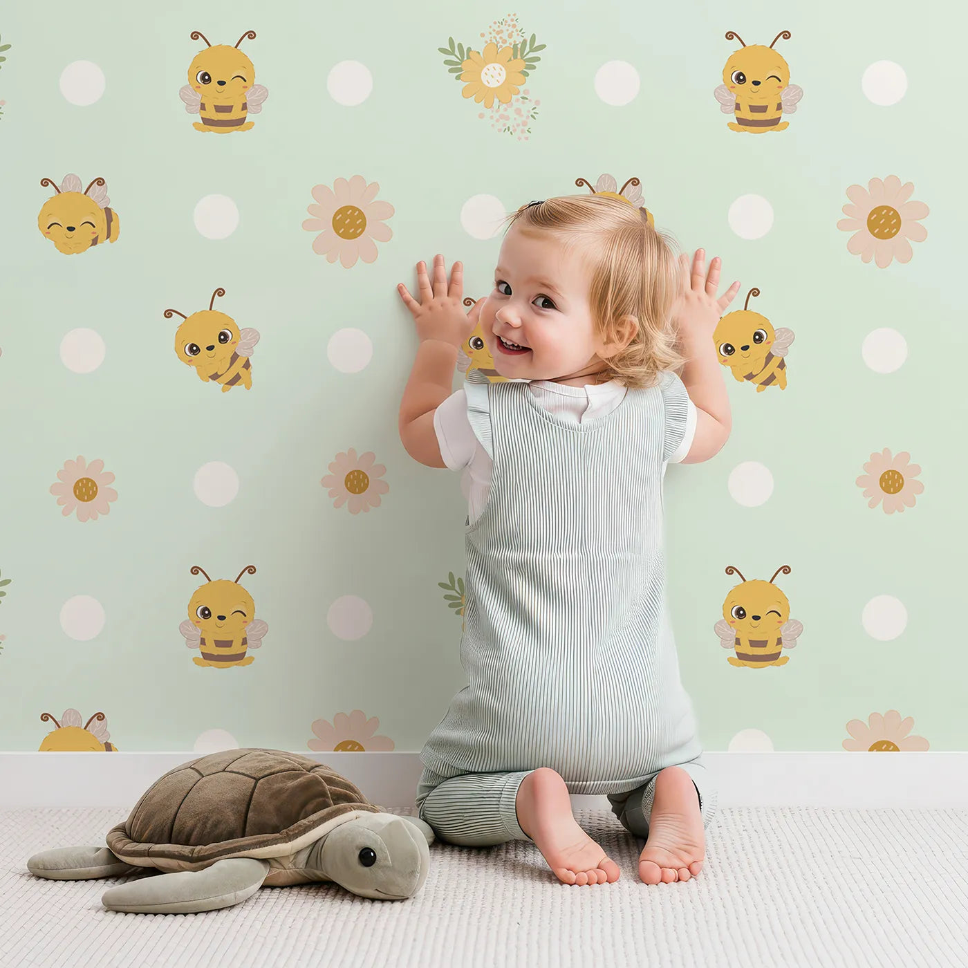 Lovely child standing in front of Whimsy Tots Buzzberry Bee Parade Wallpaper in Green with bee, flower, daisy, dot in design.