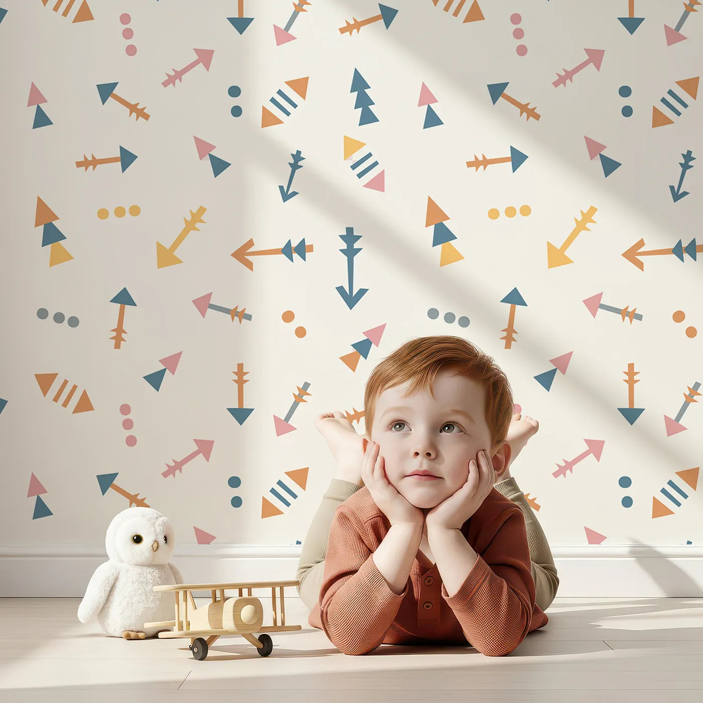 Lovely child standing in front of Whimsy Tots Boho Arrows Wallpaper in White with arrow, triangle, dot in design.