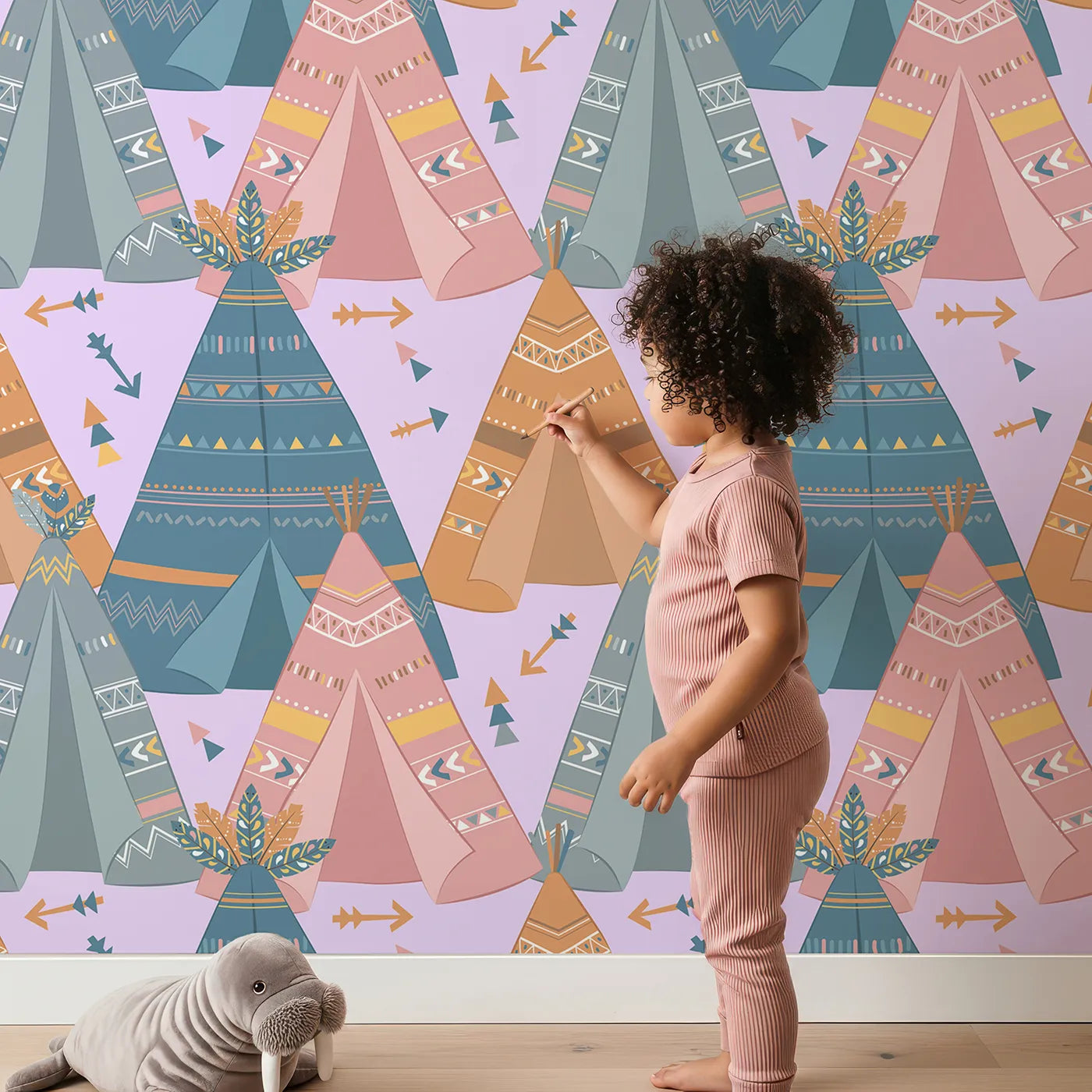 Lovely child standing in front of Whimsy Tots Teepee Parade Wallpaper in Purple with teepee, arrow, triangle, tent in design.