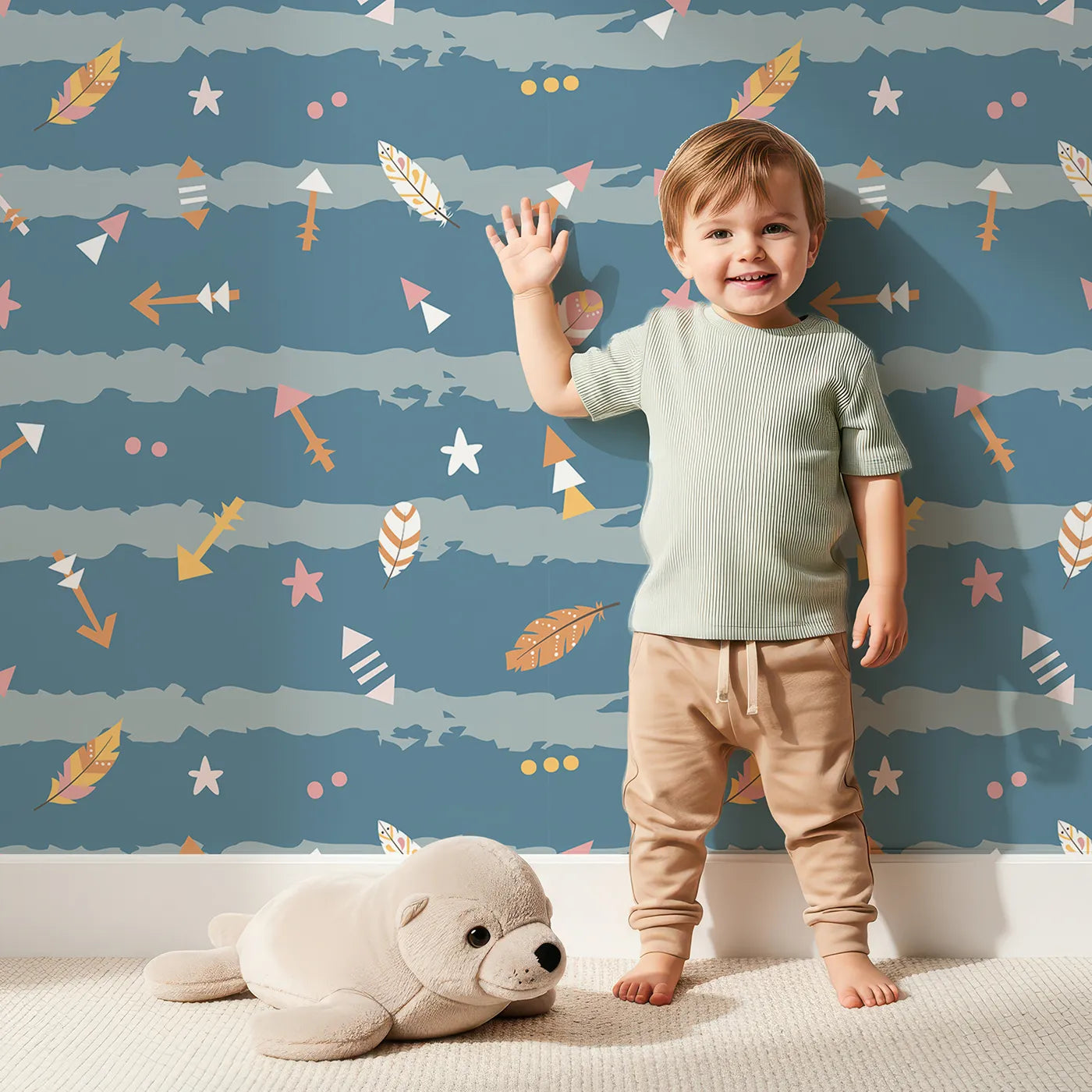 Lovely child standing in front of Whimsy Tots Tribal Sky Dance Wallpaper with arrow, feather, star, stripe in design.