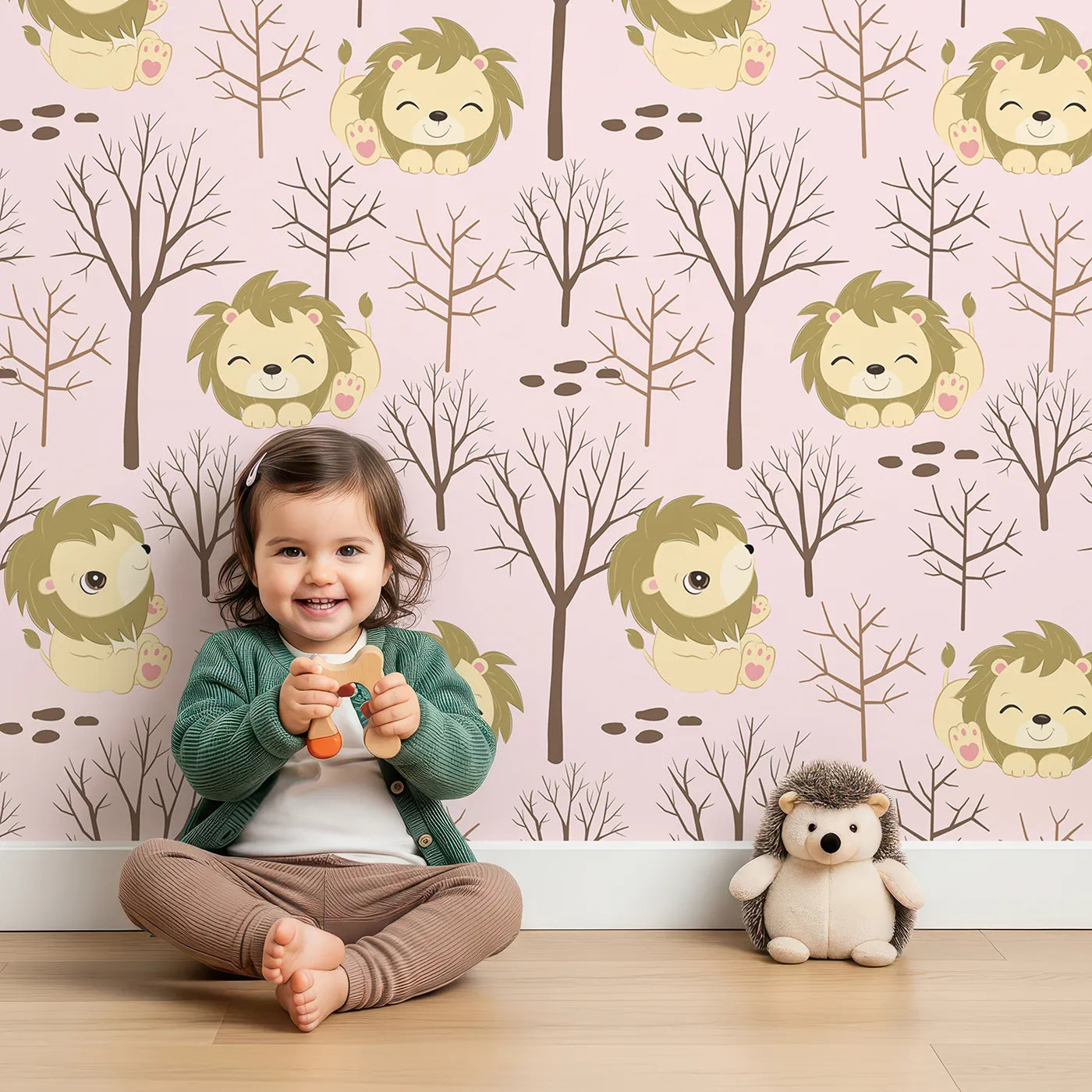 Lovely child standing in front of Whimsy Tots Little Lion Nap Wallpaper in Pink with lion, tree, footprint in design.