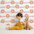 Lovely child standing in front of Whimsy Tots Striped Safari Cubs Wallpaper in Blush Pink with lion, stripe, paw in design. Lovely child standing in front of Whimsy Tots Striped Safari Cubs Wallpaper in Blush Pink with lion, stripe, paw in design.