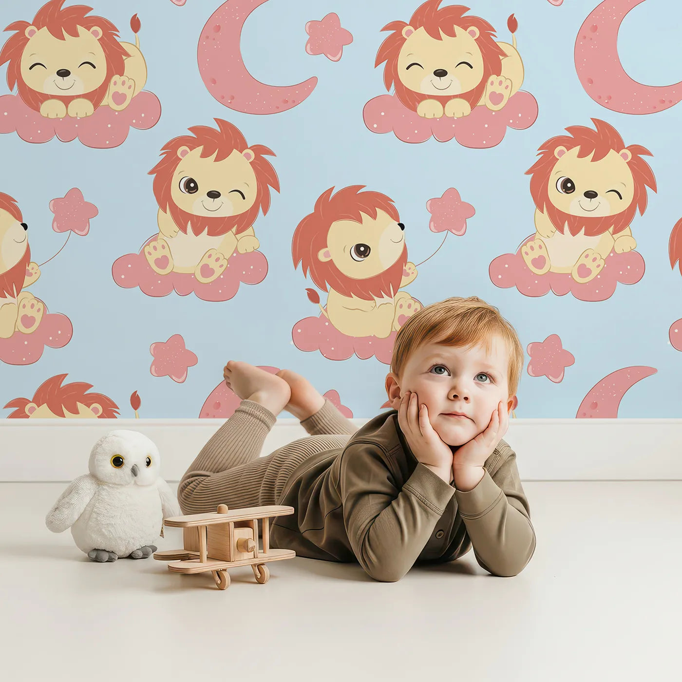 Lovely child standing in front of Whimsy Tots Starry Safari Dreams Wallpaper in Blue with lion, cloud, moon, star in design.