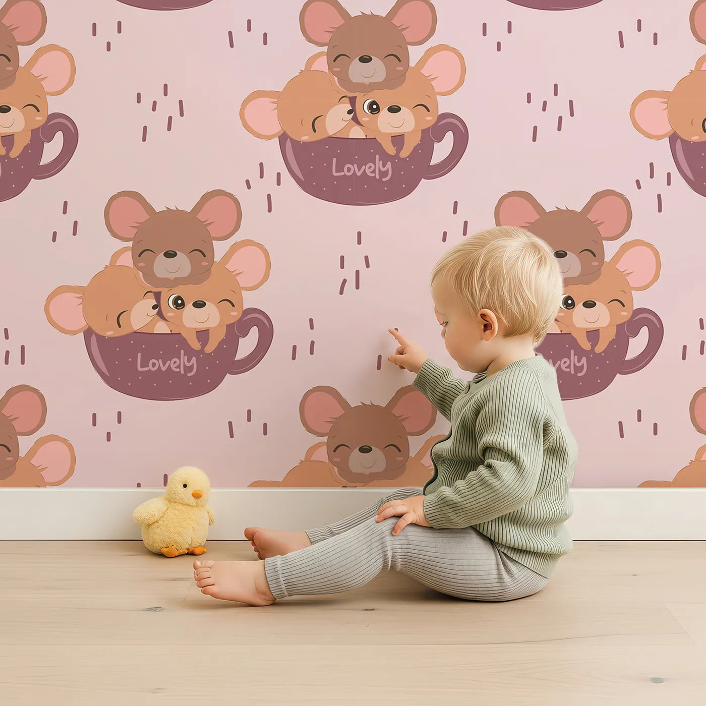 Lovely child standing in front of Whimsy Tots Lovely Tea Mice Wallpaper in Pink with mouse, cup, sprinkle in design.