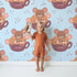 Lovely child standing in front of Whimsy Tots Lovely Tea Mice Wallpaper in Blue with mouse, cup, sprinkle in design. Lovely child standing in front of Whimsy Tots Lovely Tea Mice Wallpaper in Blue with mouse, cup, sprinkle in design.