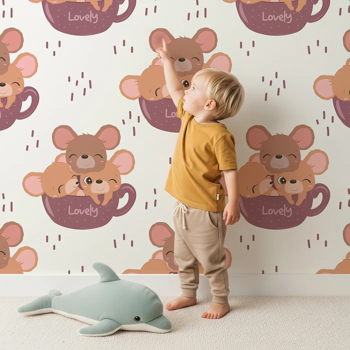 Lovely child standing in front of Whimsy Tots Lovely Tea Mice Wallpaper in White with mouse, cup, sprinkle in design.