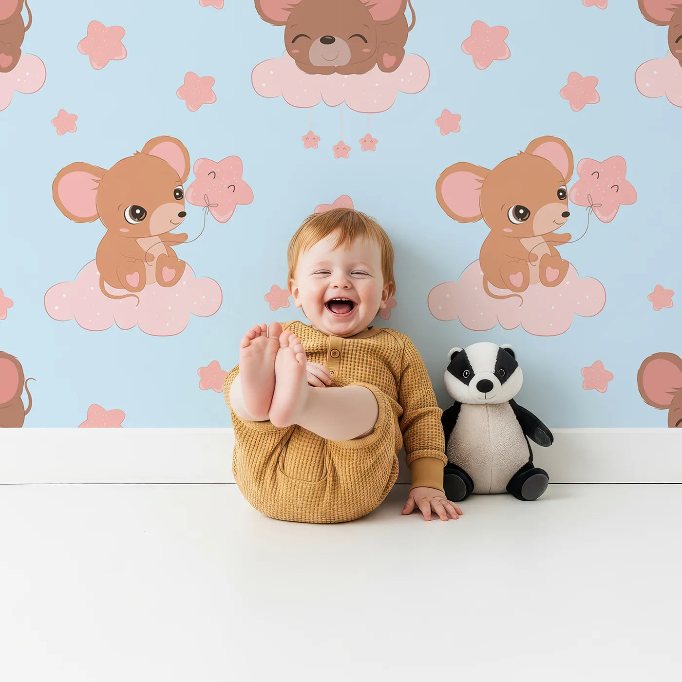 Lovely child standing in front of Whimsy Tots Starry Cloud Mouse Wallpaper in Blue with mouse, cloud, balloon, star in design.